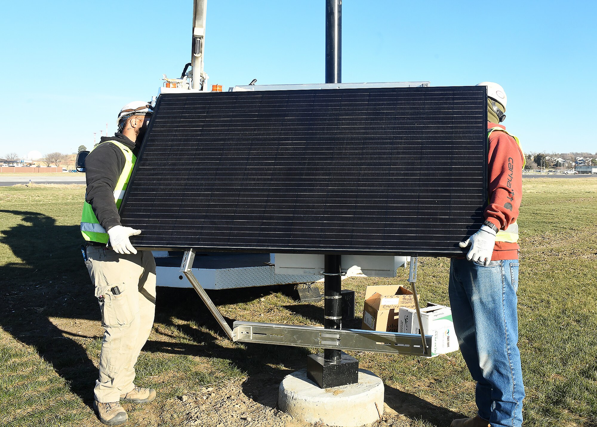 Men install a solar panel