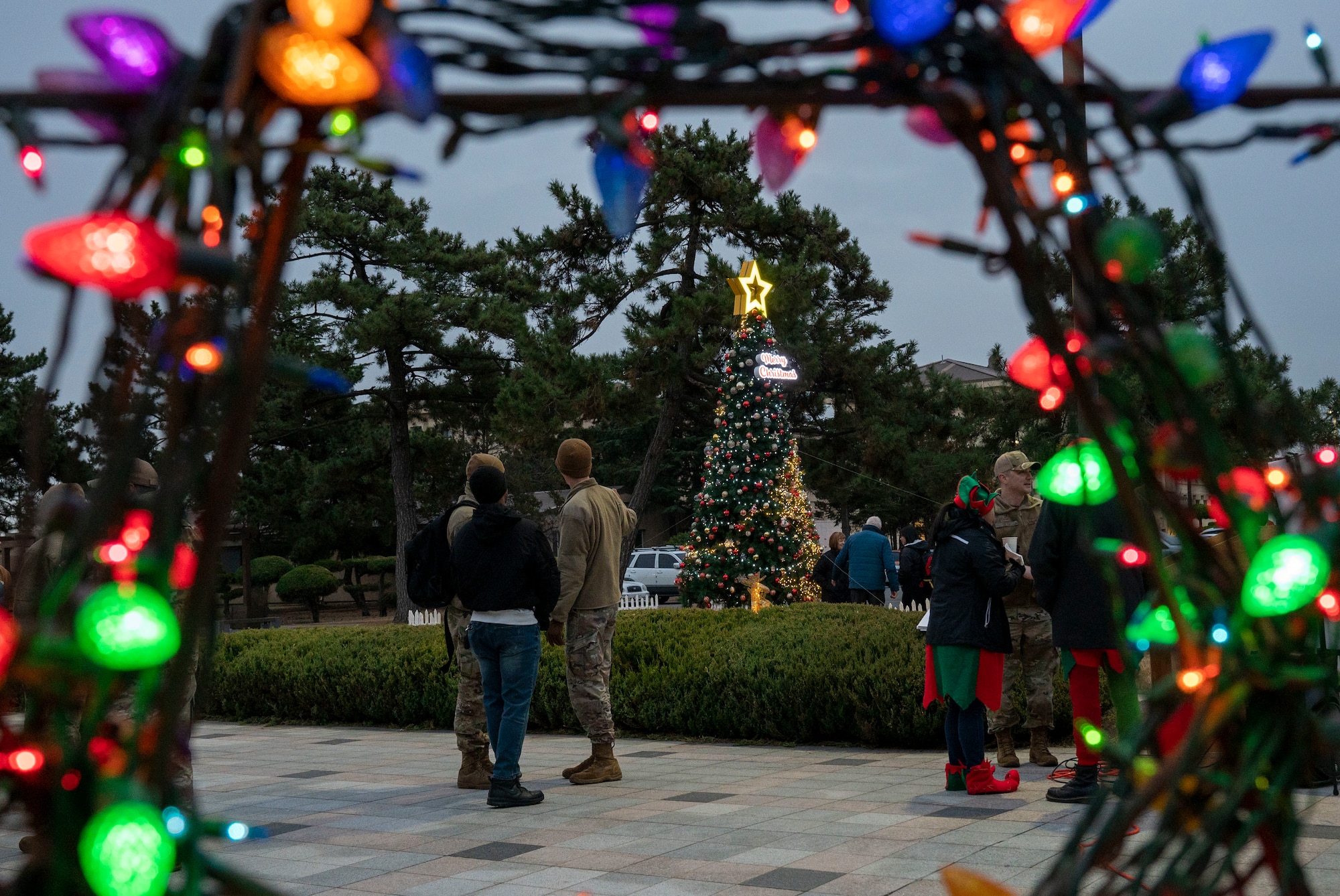 Airmen from the 8th Fighter Wing gather after the holiday tree lighting ceremony at Kunsan Air Base, Republic of Korea, Dec. 1, 2022. Tree lighting ceremonies are an annual tradition on most military installations. (U.S. Air Force photo by Tech. Sgt. Timothy Dischinat)