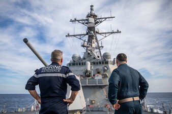 John Mastriani, right, commanding officer of the Arleigh Burke-class guided-missile destroyer USS Roosevelt (DDG 80), gives a tour of the forecastle to French Rear Adm. Christophe Cluzel, left, commander, French Carrier Strike Group (CSG), during his visit, Nov. 27, 2022.