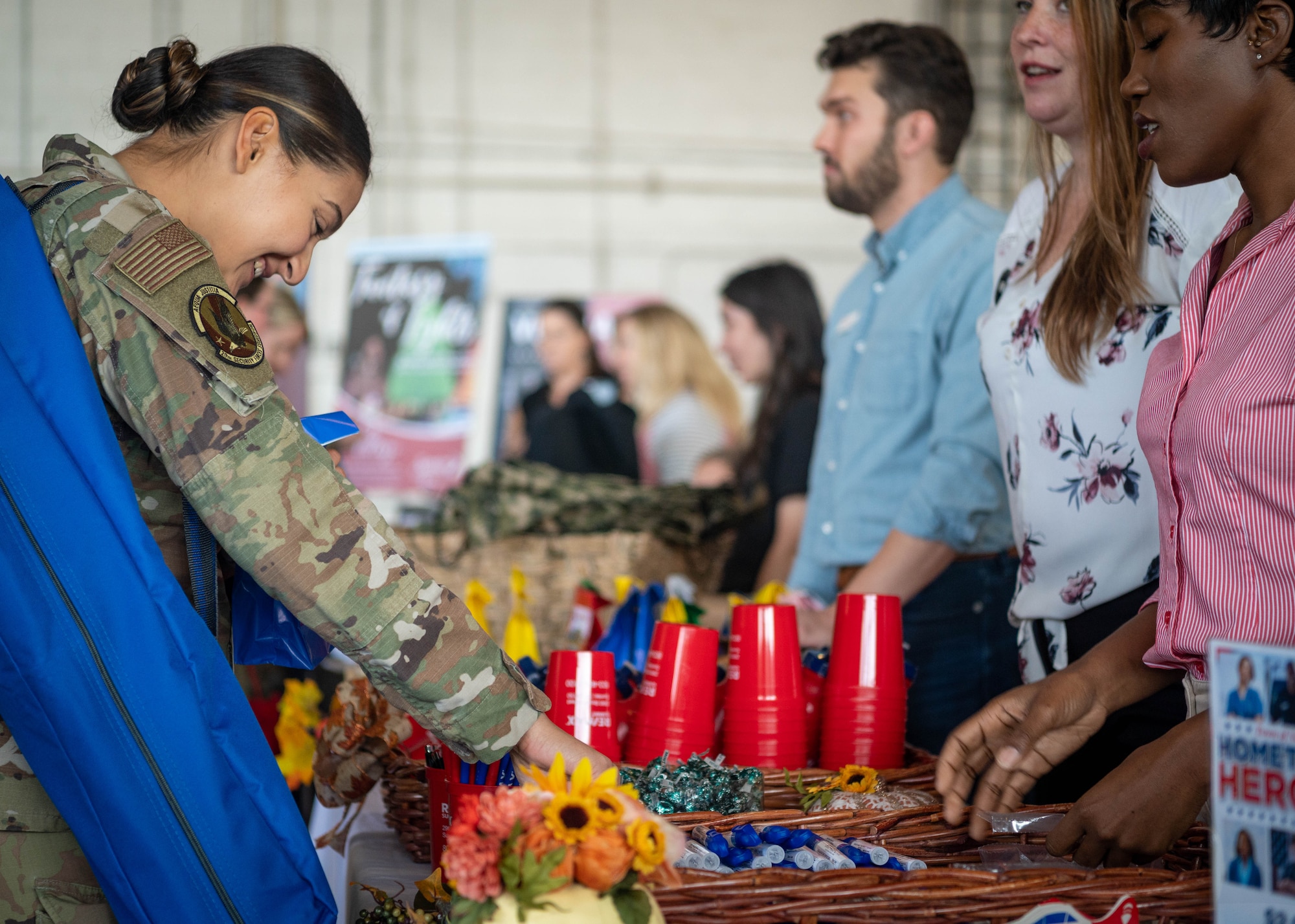 Military attendee collects a pamphlet from a local vendor at the Military Appreciation Picnic.