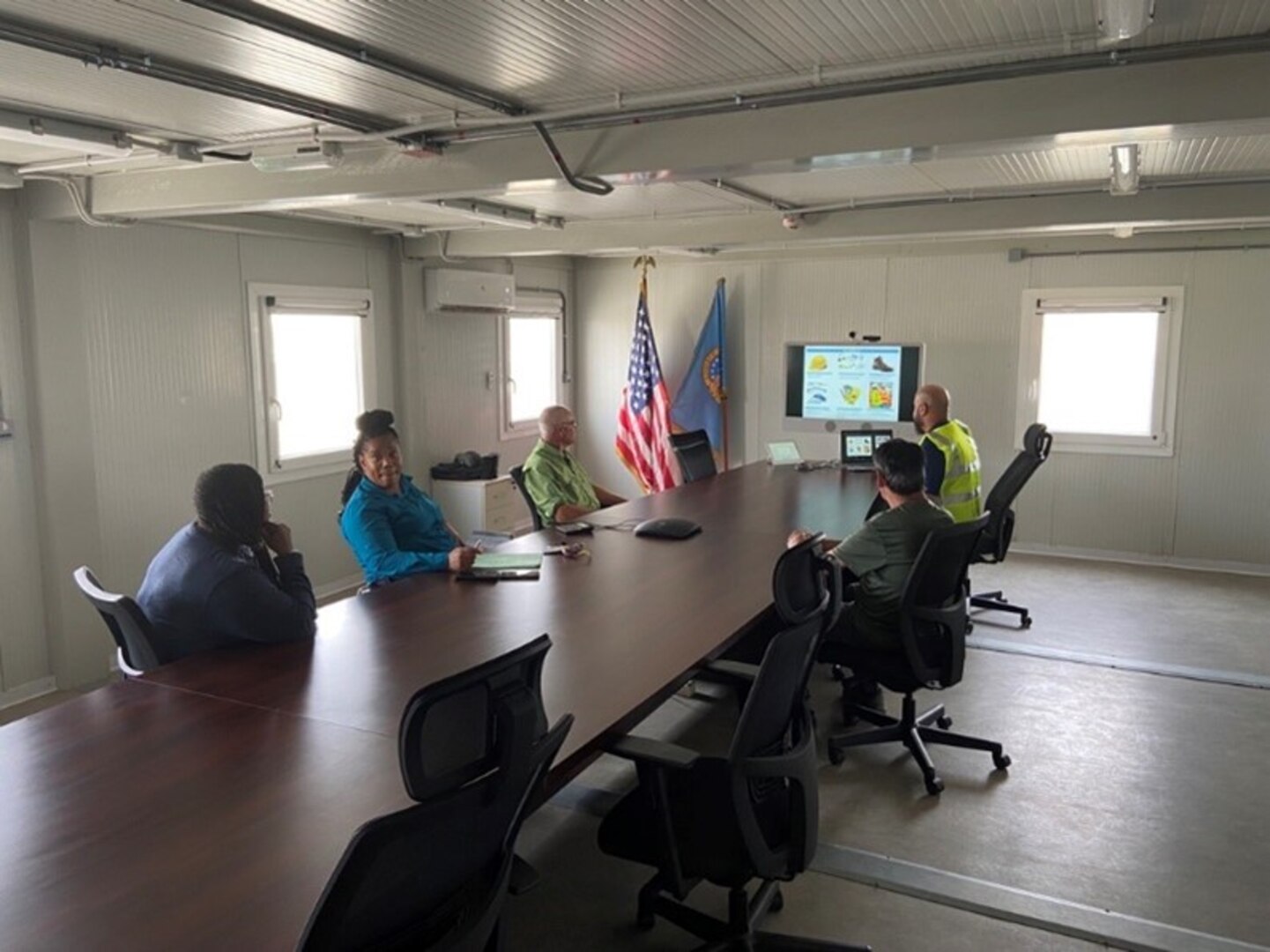 people at conference table for briefing