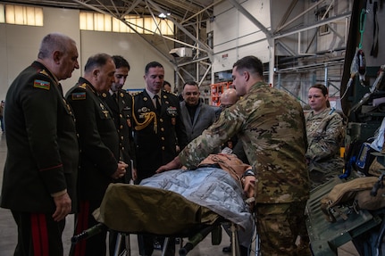airmen treat a simulated patient on a gurney