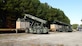 U.S. Soldiers with the 11th Transportation Battalion, 7th Transportation Brigade (Expeditionary), operate Rough Terrain Cargo Handlers to load cargo containers onto rail cars at Joint Base Langley-Eustis, Virginia, November 16, 2022. The cargo containers are filled with supplies that will support the National Science Foundation at McMurdo Station, Antarctica, which is part of Operation Deep Freeze. (U.S. Air Force photo by Abraham Essenmacher)