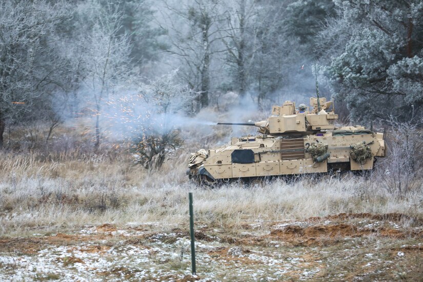 U.S. Soldiers assigned to Chaos Company, 3rd Battalion, 8th Cavalry Regiment, 3rd Armored Brigade Combat Team, 1st Cavalry Division (3-1 ABCT) operationally controlled by the 1st Infantry Division (1 ID), fire a M3 Bradley Fighting Vehicle 20mm cannon at simulated targets during the Bull Run live fire exercise in Bemowo Piskie, Poland, Nov. 23, 2022. The 3-1 ABCT is among other units assigned to the 1 ID, proudly working alongside NATO allies and regional security partners to provide combat-credible forces to V Corps, America's forward deployed corps in Europe. (U.S. Army National Guard photo by Sgt. Gavin K. Ching)