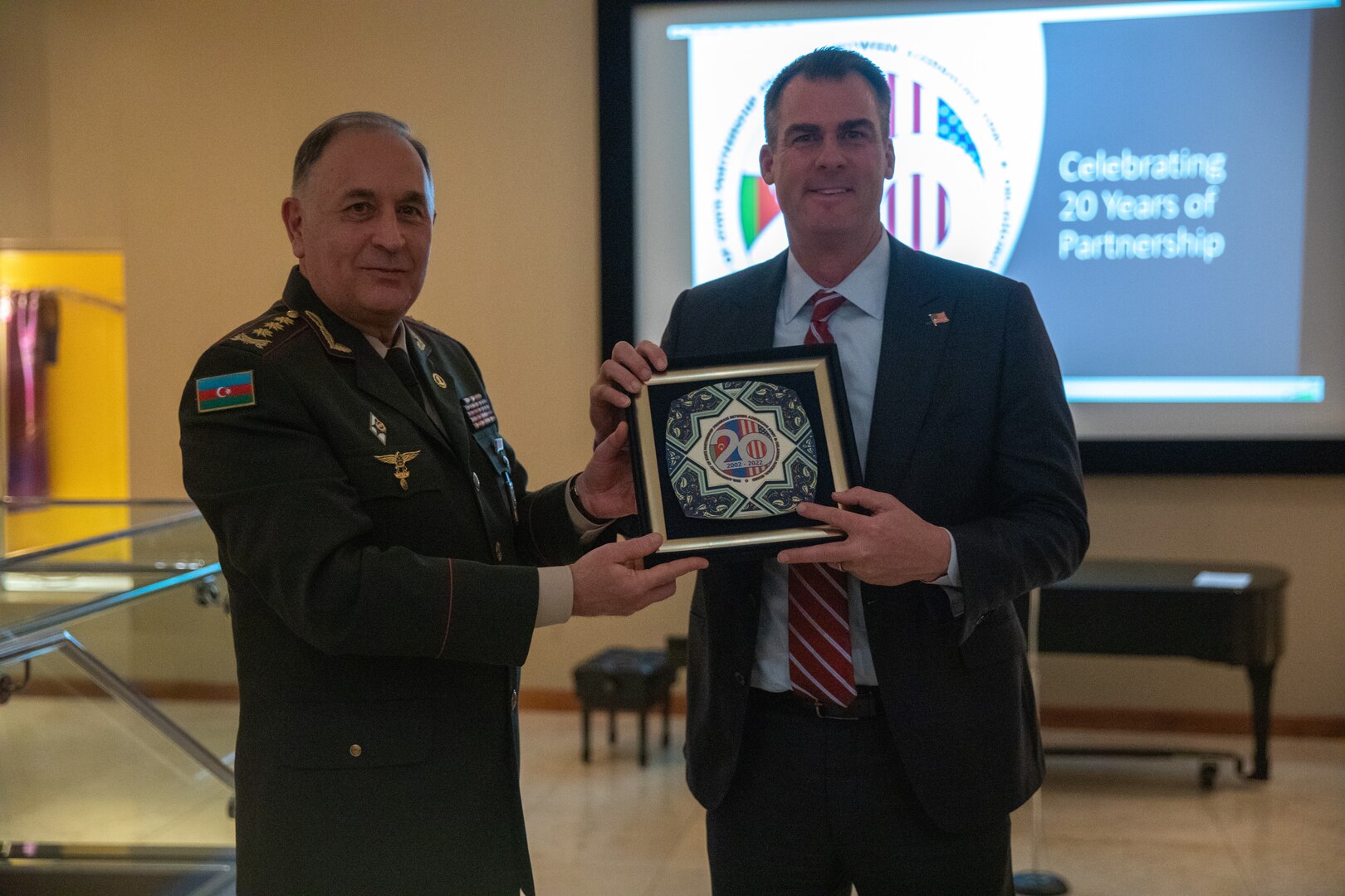 Col. Gen. Karim Valiyeva, first deputy minister of defense and chief of the general staff of the Azerbaijan Army, presents a gift to Oklahoma Gov. Kevin Stitt at the Oklahoma City Museum of Art Nov. 30, 2022. Oklahoma National Guard leaders and a delegation from Azerbaijan met to celebrate their 20-year partnership under the Department of Defense National Guard Bureau State Partnership Program.