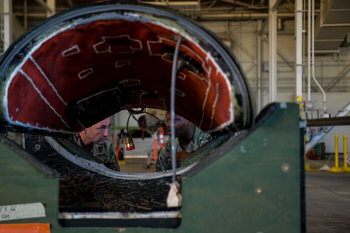 Staff Sgt. Zachary Moore, 9th Maintenance Group U-2 avionics craftsman, right, briefs Lt. Gen. Kevin Kennedy, 16th Air Force commander, on parts of the U-2 Dragon Lady during an immersion tour at Beale Air Force Base, California, Nov. 29, 2022.