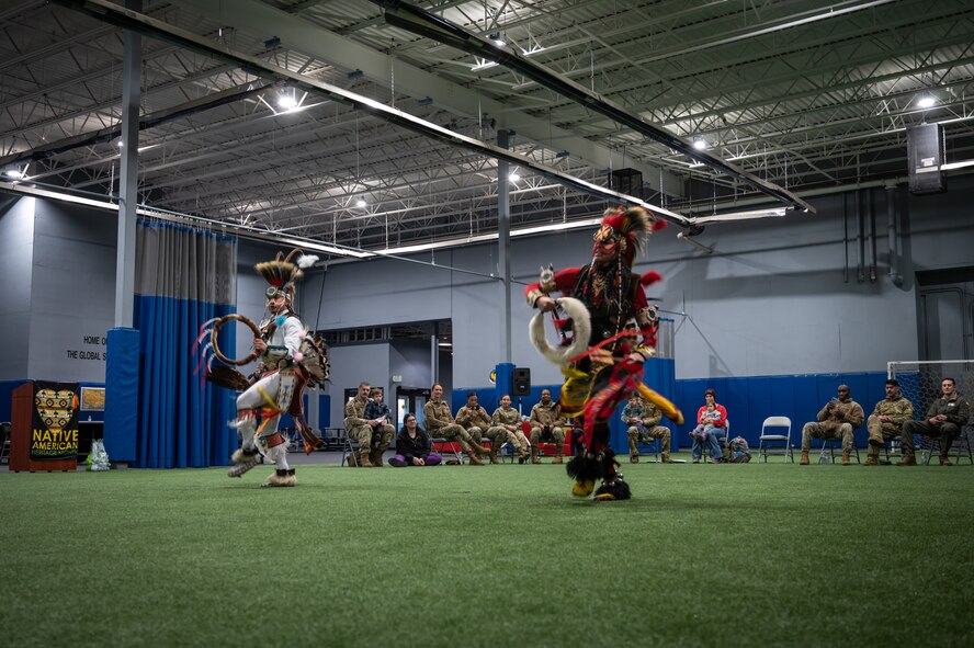 Two Native American dancers perform at the Native American Heritage Month closing ceremony at Minot Air Force Base, North Dakota, Nov. 30, 2022. During the ceremony, attendees learned about Native American culture from local tribes and Native American Airmen. (U.S. Air Force photo by Airman 1st Class Alexander Nottingham)