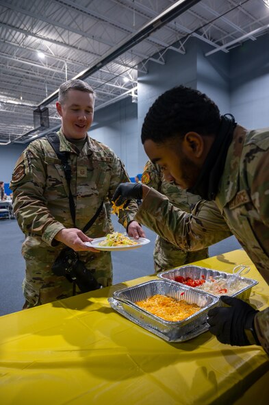 Master Sgt. Ryan Bell, 791st Missile Security Forces Squadron, is served Native American Tacos at the Native American Heritage Month closing ceremony on Minot Air Force Base, North Dakota, Nov. 30, 2022. During the ceremony, attendees learned about Native American culture from local tribes and Native American Airmen. (U.S. Air Force photo by Airman 1st Class Alexander Nottingham)