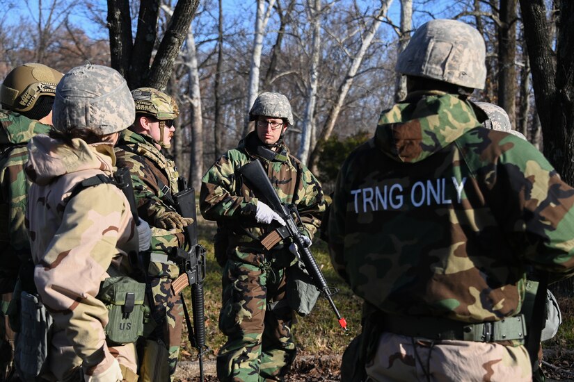 Joint Base Andrews Airmen gather to discuss their action plan during Airman Combat Skills Training at JBA, Md., December 2, 2022. ACST was a two-day event that focused on building basic combat skills and utilizing them in high-stress environments. (U.S. Air Force photo by Airman 1st Class Isabelle Churchill)