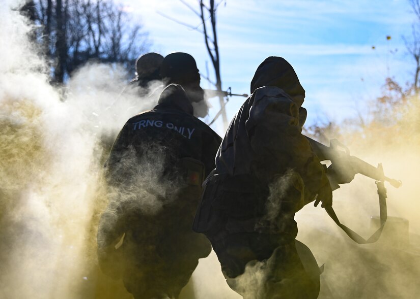 Joint Base Andrews Airmen run through a chemical gas simulation during Airman Combat Skills Training at JBA, Md., Dec. 2, 2022. ACST was a two-day event that focused on building basic combat skills and utilizing them in high-stress environments. (U.S. Air Force photo by Airman 1st Class Isabelle Churchill)