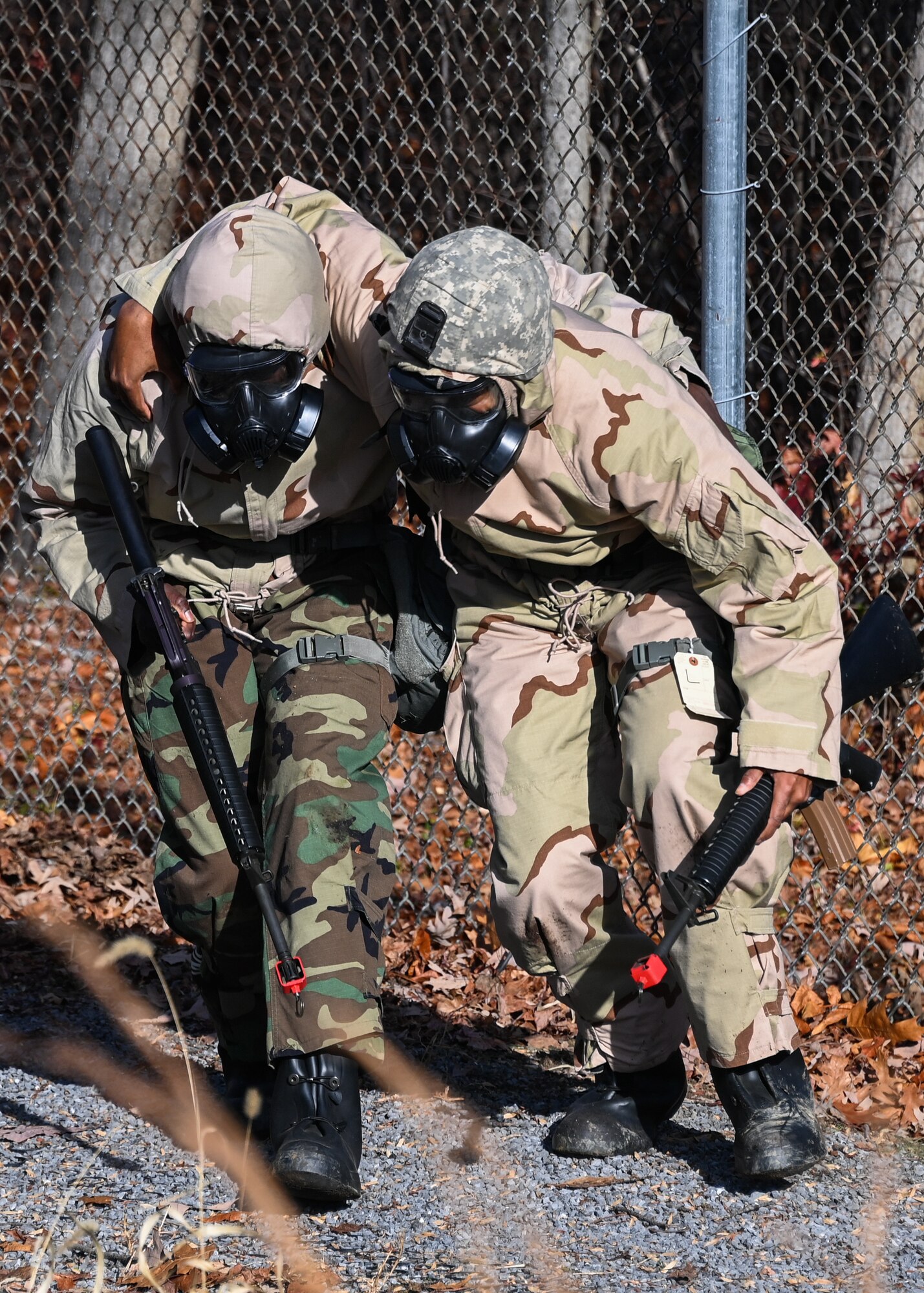 A Joint Base Andrews Airman assists their wingman during Airman Combat Skills training at JBA, Md., Dec. 2, 2022. Airmen participated in a refresher course on Tactical Combat Casualty Care before being evaluated in a high-stress simulation. (U.S. Air Force photo by Airman 1st Class Isabelle Churchill)