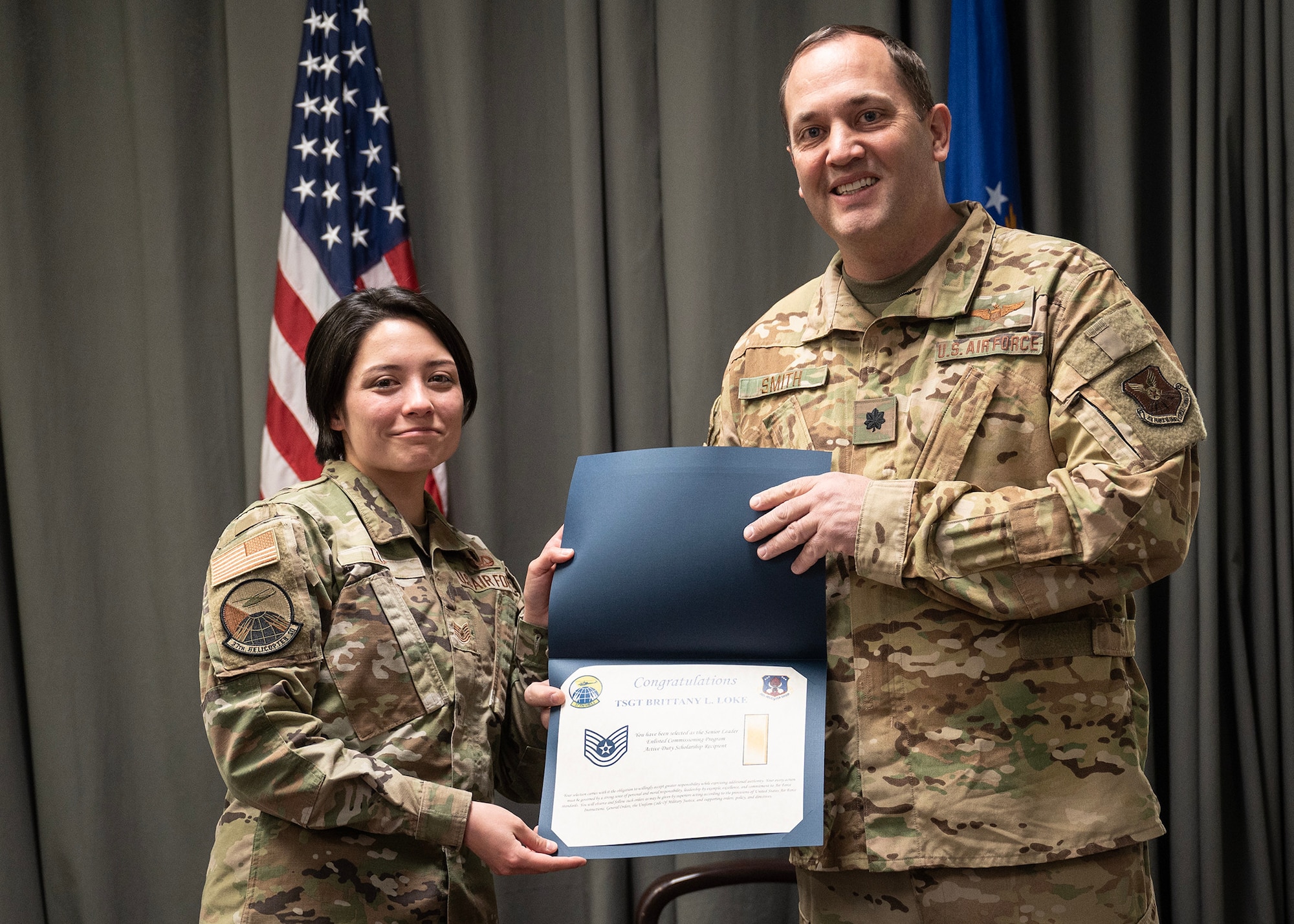 Airman receiving certificate from officer