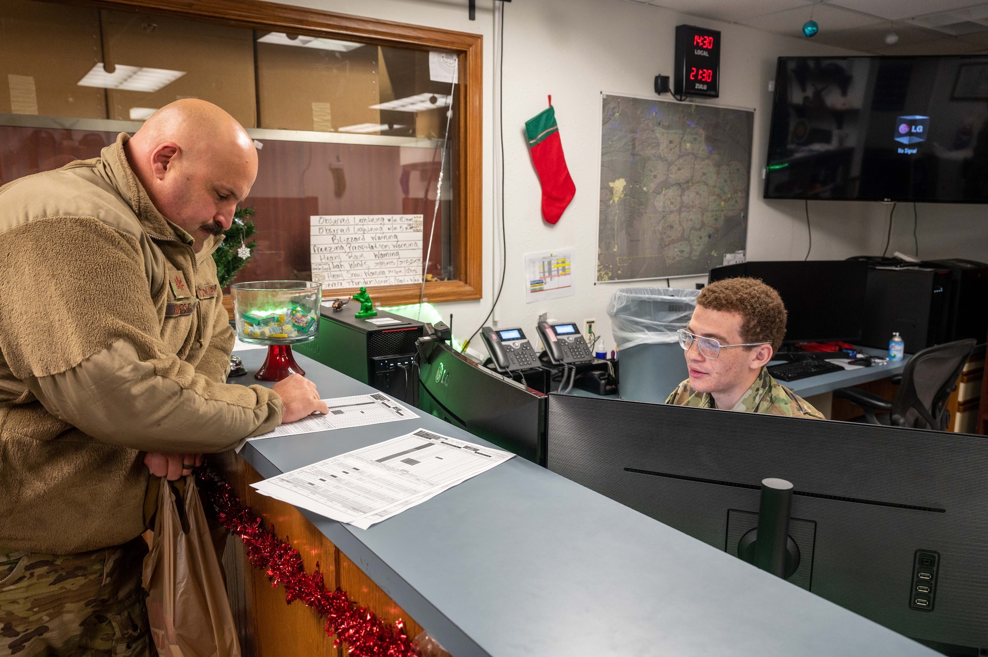 weather forecaster discussing weather conditions with pilot