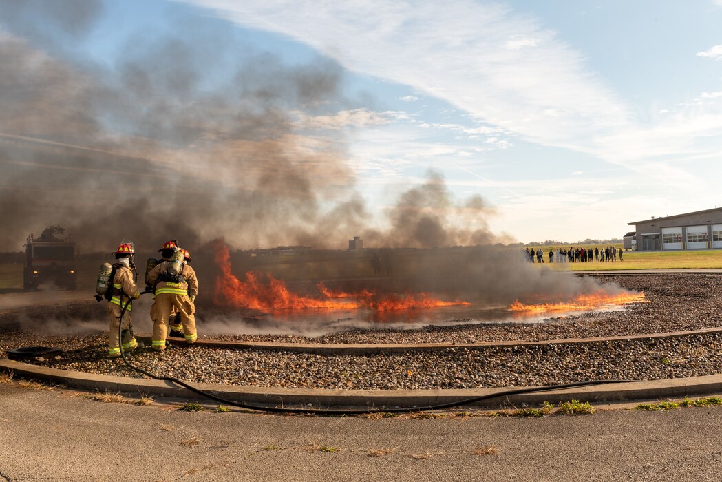 Firefighters extinguishing burn pit.