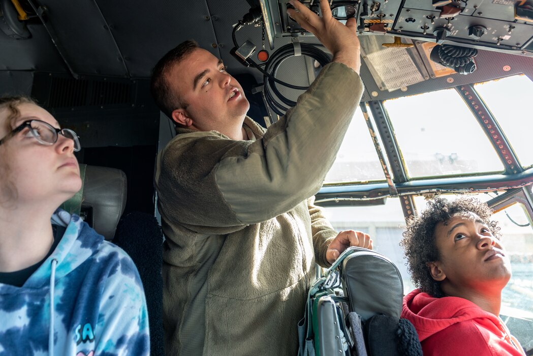 Airman explaining flight deck to students.