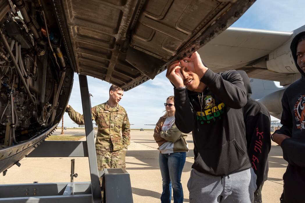 Student looking at engine.
