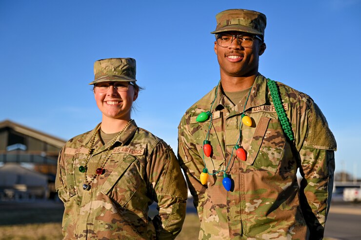 U.S. Air Force Airman Rayanna King, 312th Training Squadron student, poses for a photo alongside Airman Nathaniel Hubbard, 312th TRS student, during the 17th Training Wing tree lighting ceremony, Goodfellow Air Force Base, Texas, December 2, 2022. Students from across the base came to volunteer at the event in order to give back to the base community and raise morale. (U.S. Air Force photo by Senior Airman Michael Bowman)