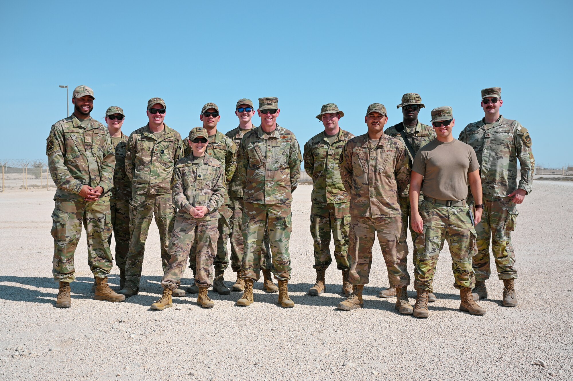 Task Force 99 members take a team photo with Maj. Gen. Clark J. Quinn, Deputy Commander Ninth Air Force (Air Forces Central), at Al Udeid Air Base, Qatar, November 18, 2022. Gen. Quinn visited the TF99 lab and observed a demonstration of one of their original technologies that is in development. (U.S. Air Force photo by Senior Airman Micah Coate)