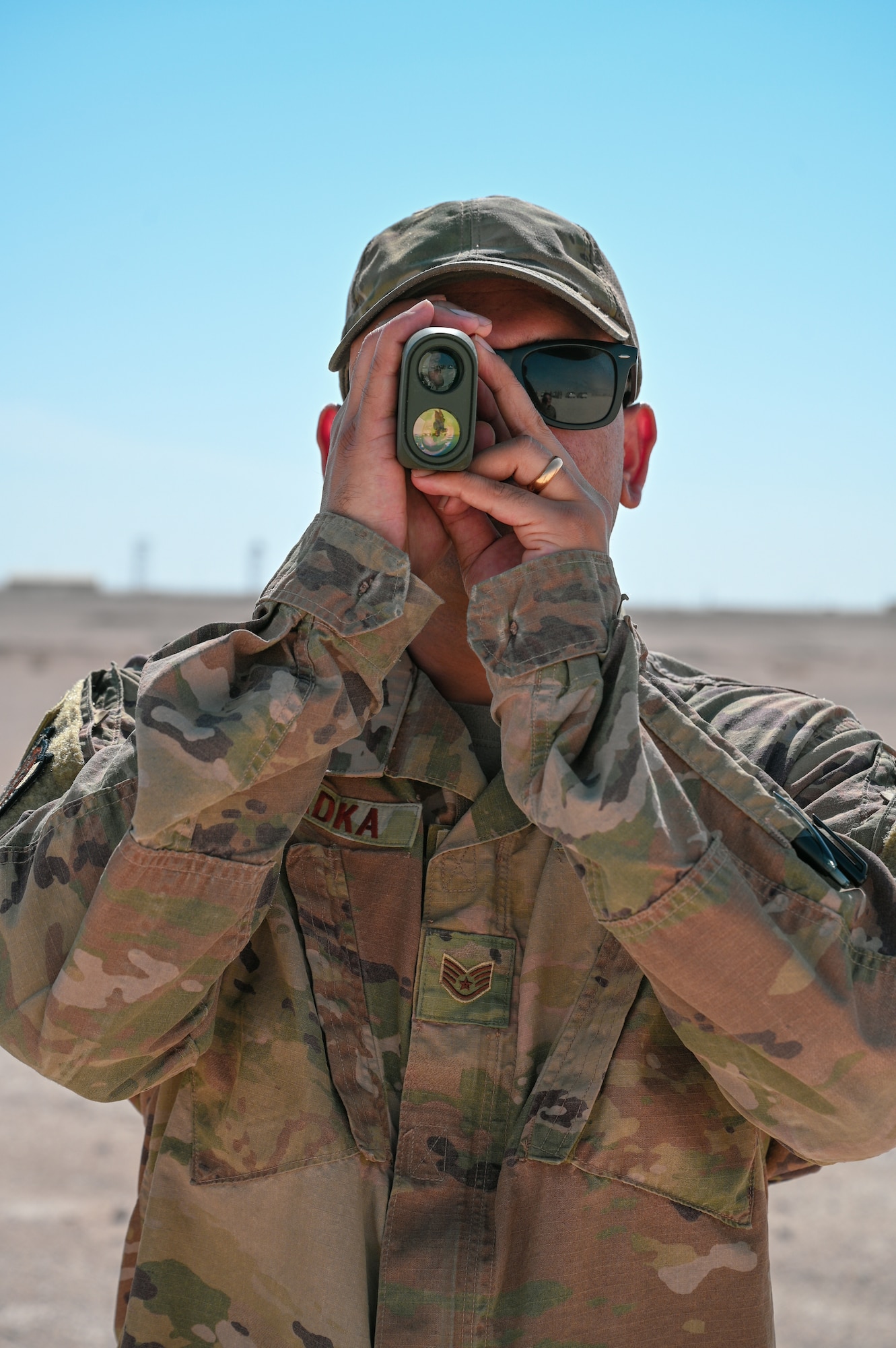 SSgt. Sagar Khadka, and electrical engineer with Task Force 99, uses a rangefinder during a TF99 technology demo at Al Udeid Air Base, Qatar, November 18, 2022. TF99 become an official Air Force organization Oct 13, 2022 and is Ninth Air Force's (Air Forces Central) contribution to U.S. Central Command’s intent of building a Culture of Innovation. (U.S. Air Force photo by Senior Airman Micah Coate)