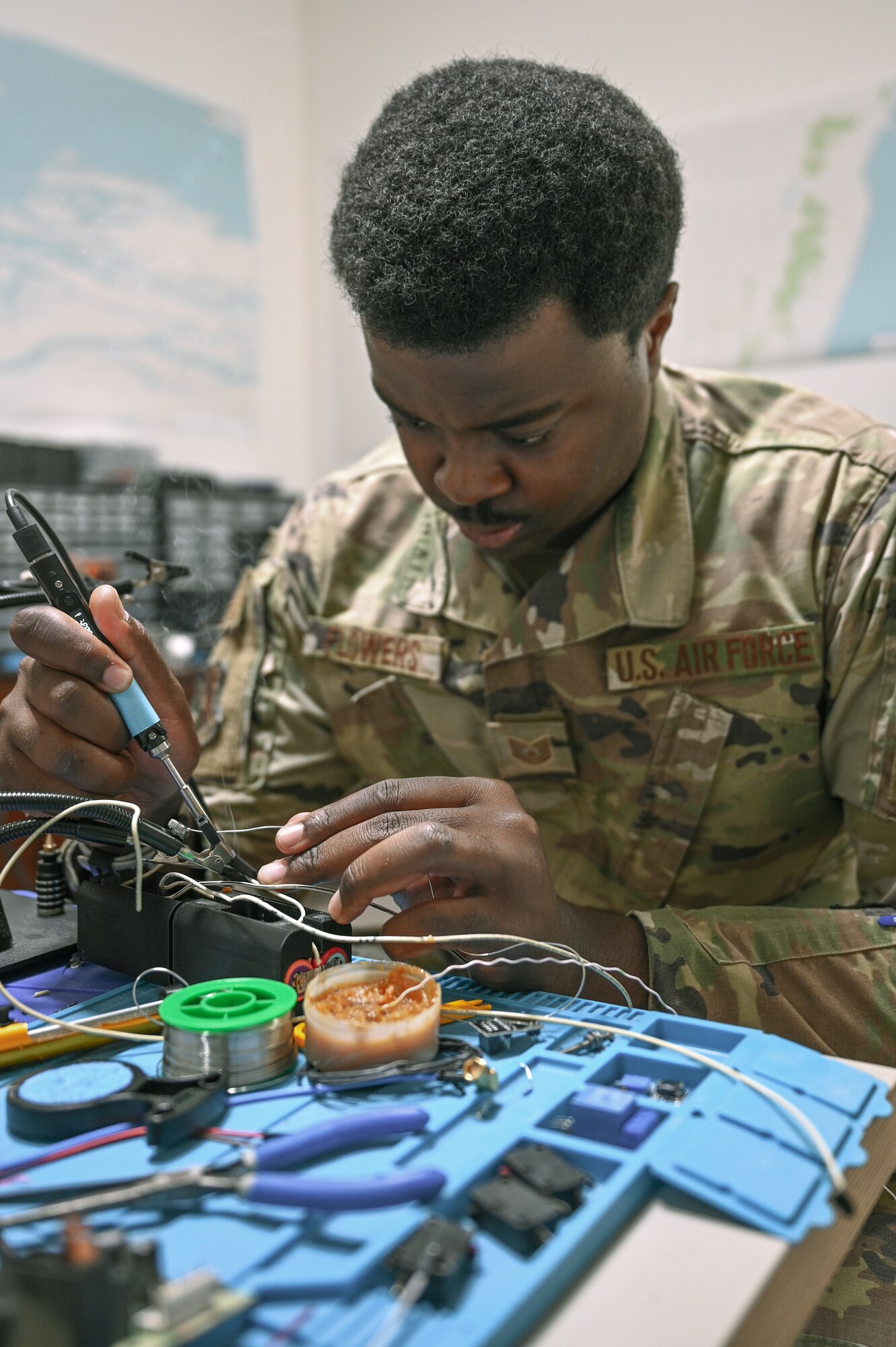 Technical Sgt. Malik Flowers, an installation spectrum manager with Task Force 99, solders components at the TF 99 lab at Al Udeid Air Base, Qatar, November 18, 2022. TF99 recruits Airmen from all career fields, who are technologically inventive and have creative mindsets. (U.S. Air Force photo by Senior Airman Micah Coate)