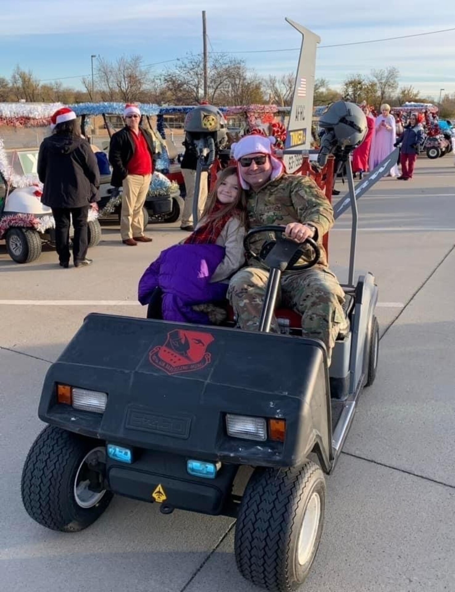 two people pose in decorated golf cart