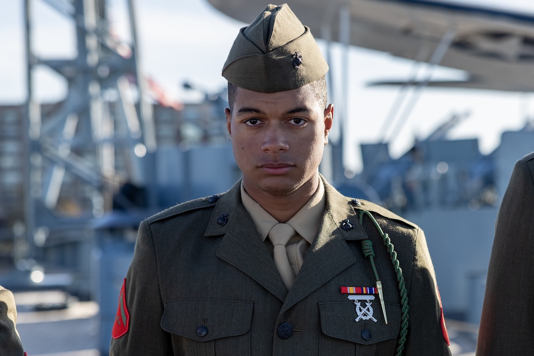 A U.S. Marine from 1st Battalion, 8th Marine Regiment, stands at attention during a naturalization ceremony aboard the Battleship USS North Carolina, Dec. 2, 2022. 18 Marines from 15 countries and five continents swore the Oath of Allegiance and received their citizenship. Naturalization is the process by which U.S. citizenship is granted to a foreign citizen after he or she fulfills the requirements to become a citizen established by Congress in the Immigration and Nationality Act of 1965. (U.S. Marine Corps photo by Cpl. Timothy Fowler)