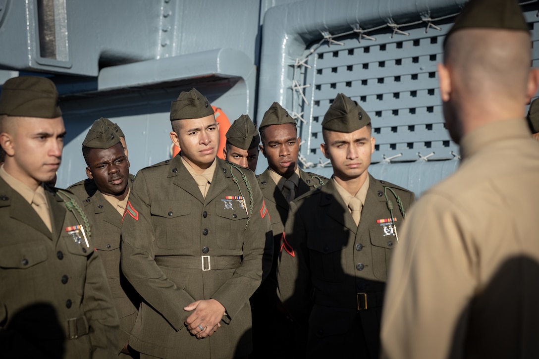 U.S. Marines from 1st Battalion, 8th Marine Regiment, listen to a speech after a naturalization ceremony aboard the Battleship USS North Carolina, Dec. 2, 2022. 18 Marines from 15 countries and five continents swore the Oath of Allegiance and received their citizenship. Naturalization is the process by which U.S. citizenship is granted to a foreign citizen after he or she fulfills the requirements to become a citizen established by Congress in the Immigration and Nationality Act of 1965. (U.S. Marine Corps photo by Lance Cpl. Noah Seal)