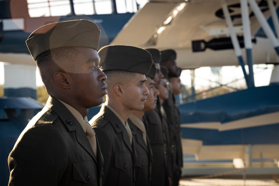 U.S. Marines from 1st Battalion, 8th Marine Regiment, stand at attention during a naturalization ceremony aboard the Battleship USS North Carolina, Dec. 2, 2022. 18 Marines from 15 countries and five continents swore the Oath of Allegiance and received their citizenship. Naturalization is the process by which U.S. citizenship is granted to a foreign citizen after he or she fulfills the requirements to become a citizen established by Congress in the Immigration and Nationality Act of 1965. (U.S. Marine Corps photo by Lance Cpl. Noah Seal)
