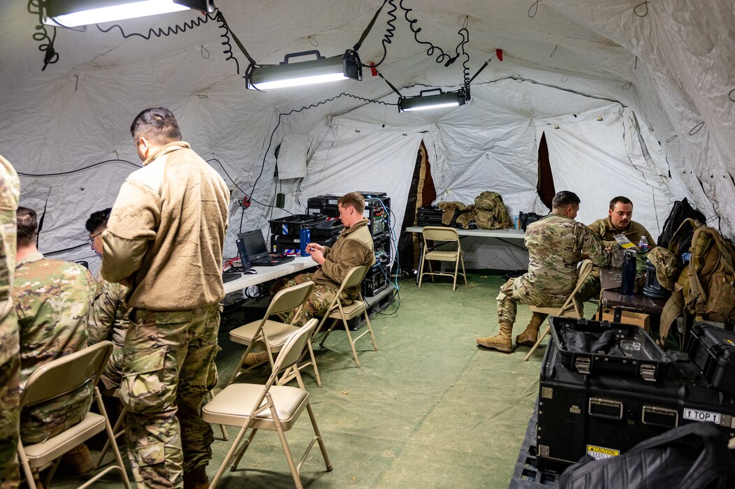 Airmen working in tent.