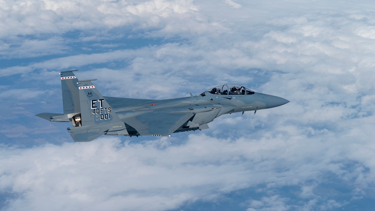 An aircraft flies above the clouds.