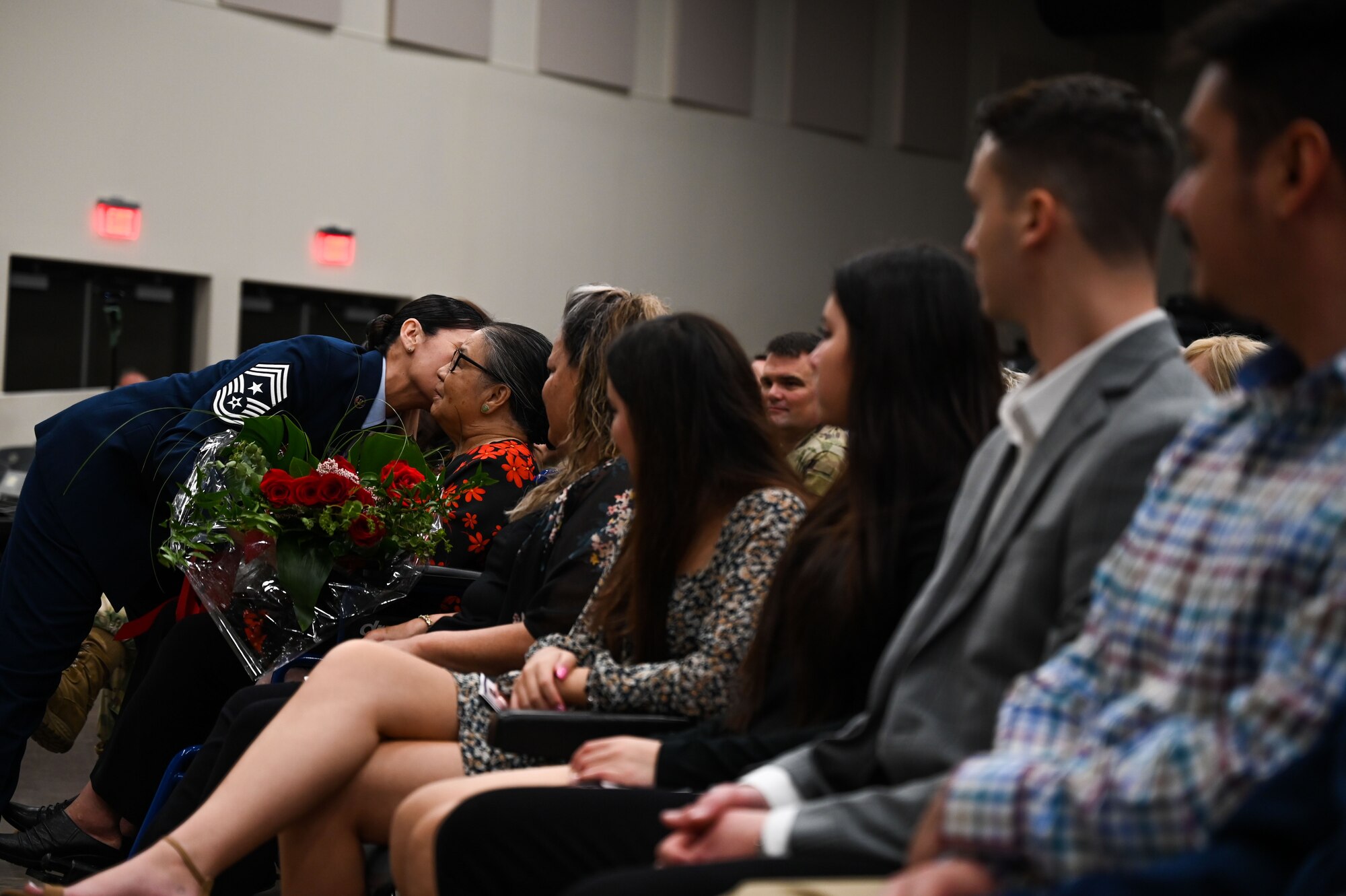 Ret. Chief Master Sgt. Billie Baber, former 960th Cyberspace Wing command chief, hands her mother flowers during her retirement ceremony, Nov. 4, 2022, at Joint Base San Antonio-Lackland, Texas. Baber entered the Air Force in 1996 and dedicated 26 years to military service. Baber’s husband and children also attended the ceremony. (U.S. Air Force photo by Staff Sgt. Adriana Barrientos)