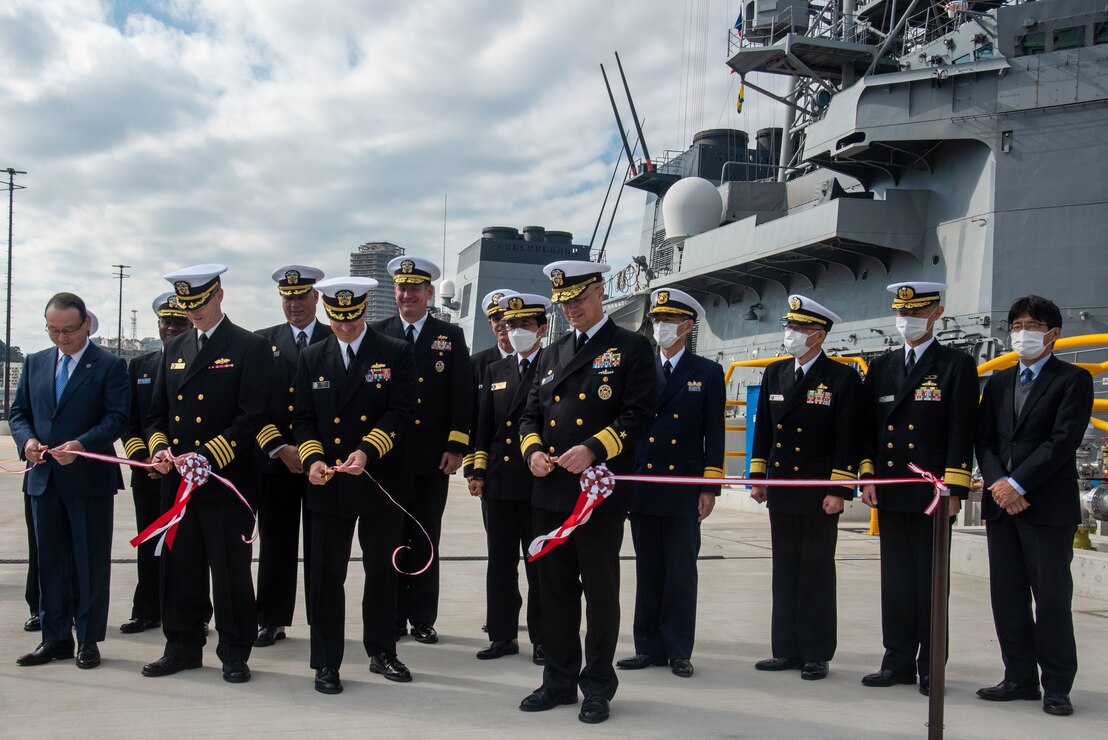 Capt. Lance Flood, Naval Facilities Engineering Systems Command Fast East, left, Capt. Leslie Sobol Commander, Fleet Activities Yokosuka, center, and Rear Adm. Carl Lahti, Commander, Navy Region Japan/ Commander, U.S. Naval Forces Japan, right, cut a ribbon during a ceremony for a newly-completed Pier 5 located onboard CFAY