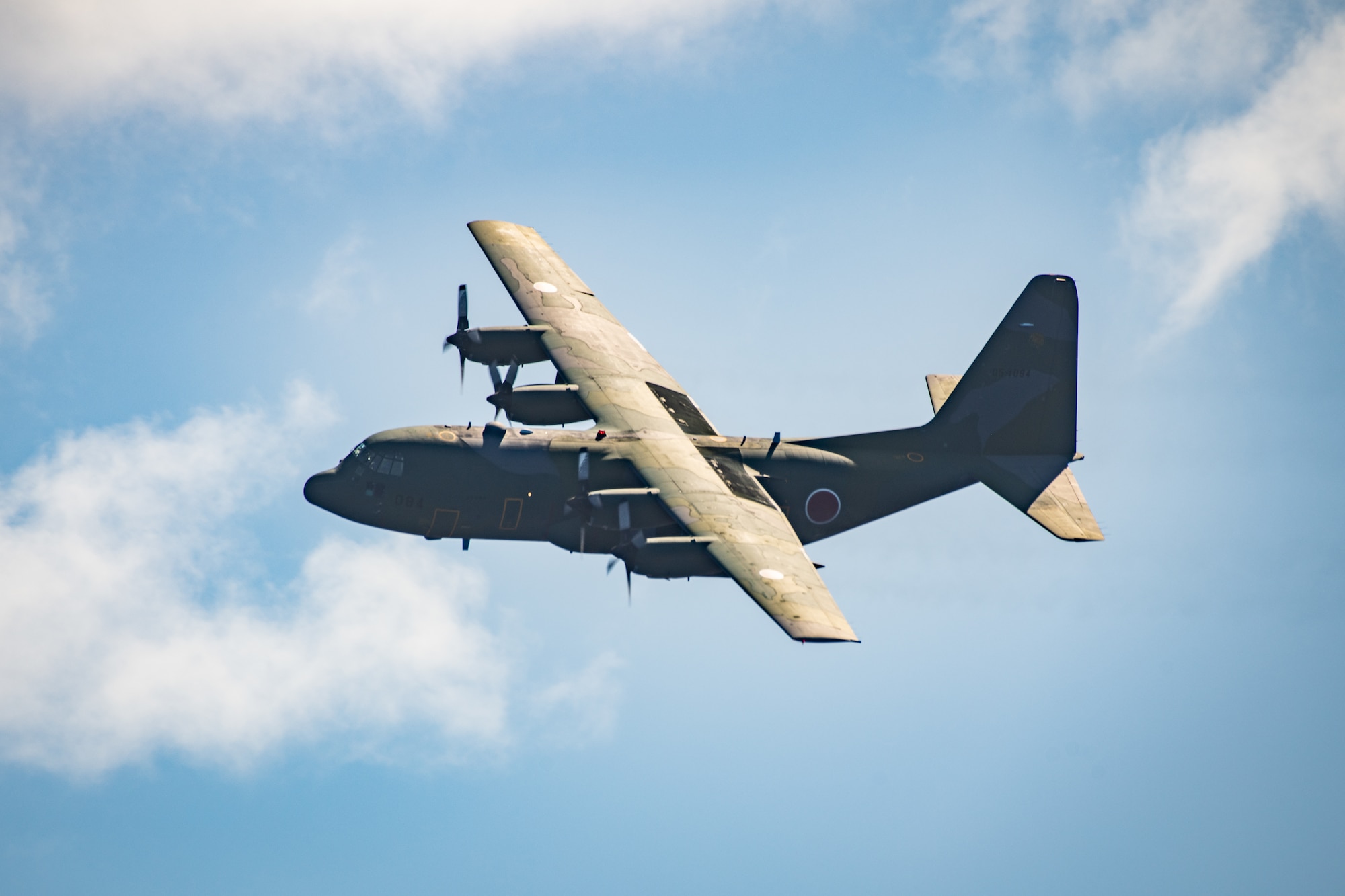 A Japan Air Self Defense Force C-130H Hercules assigned to the 401st Tactical Airlift Squadron flies over a drop zone