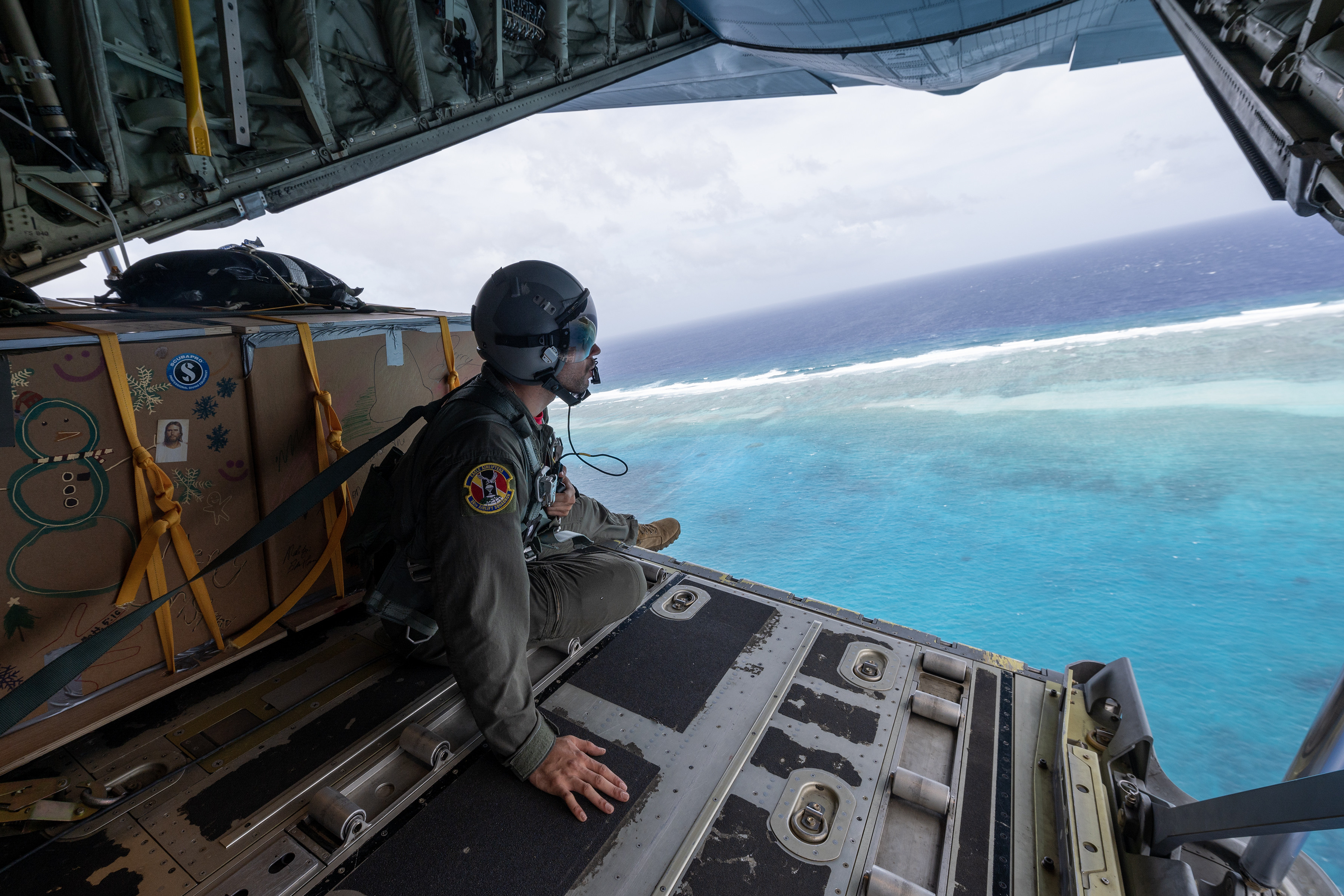 An airman conducts a visual confirmation over the Caroline Islands of the western Pacific Ocean