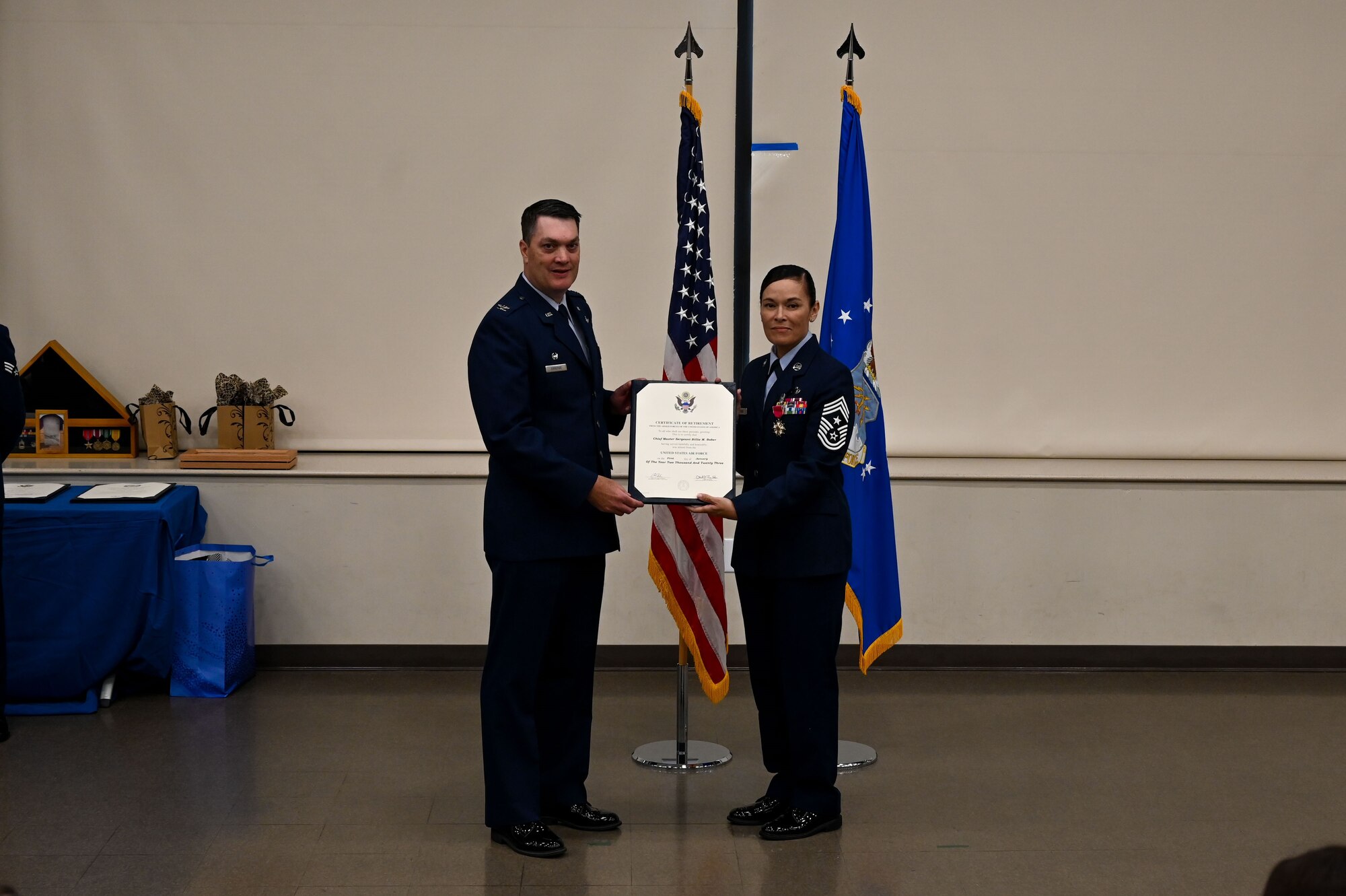 Col. Richard Erredge, 960th Cyberspace Wing commander, presents Chief Master Sgt. Billie Baber, 960th CW command chief, a certificate of retirement, Nov. 4, 2022, at Joint Base San Antonio-Lackland, Texas. Baber retired after dedicating 26 years to military service. (U.S. Air Force photo by Staff Sgt. Adriana Barrientos)