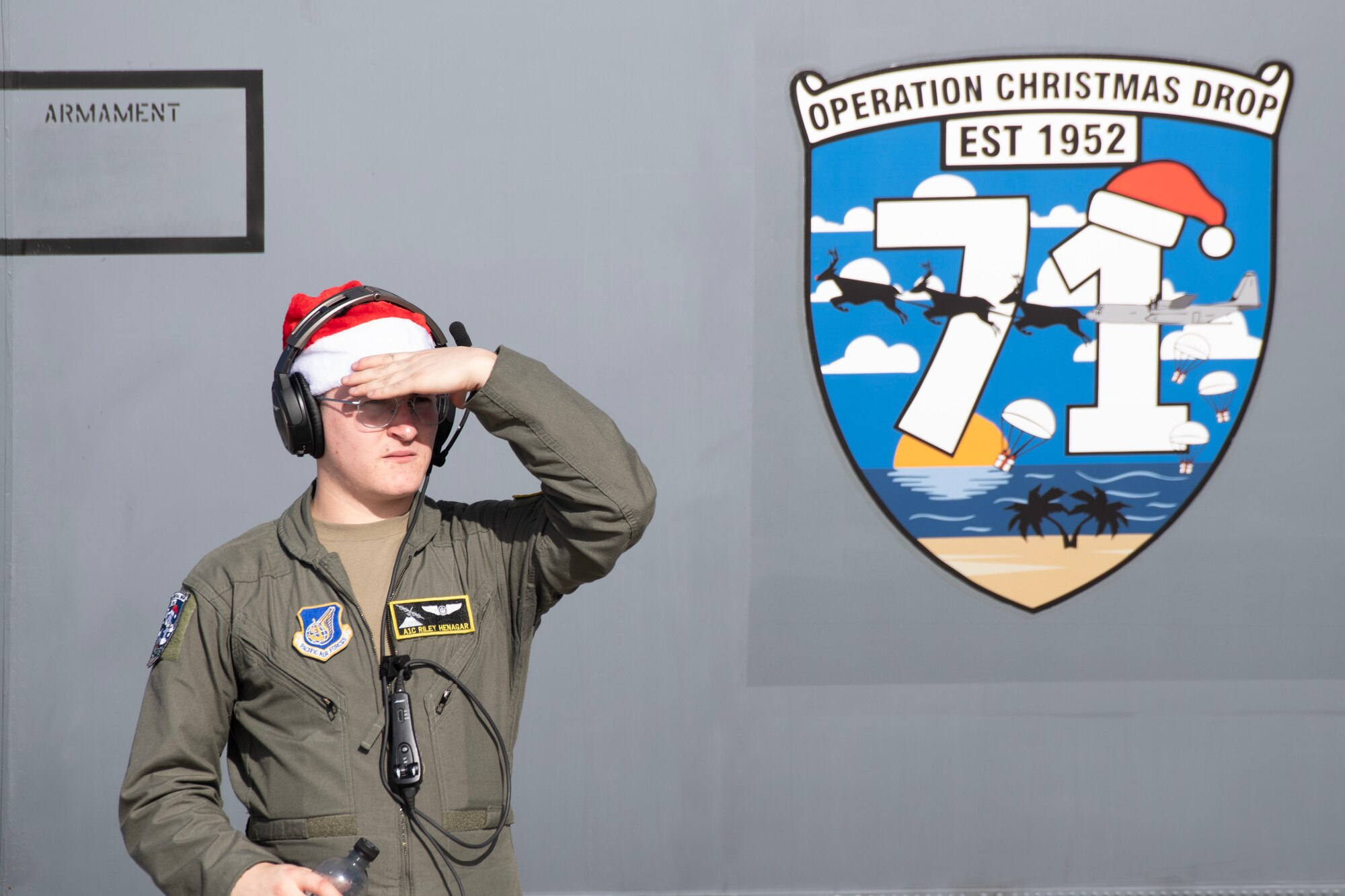 U.S. Air Force Airman 1st Class Riley Henagar, 36th Expeditionary Airlift Squadron C-130J loadmaster, looks at the flightline