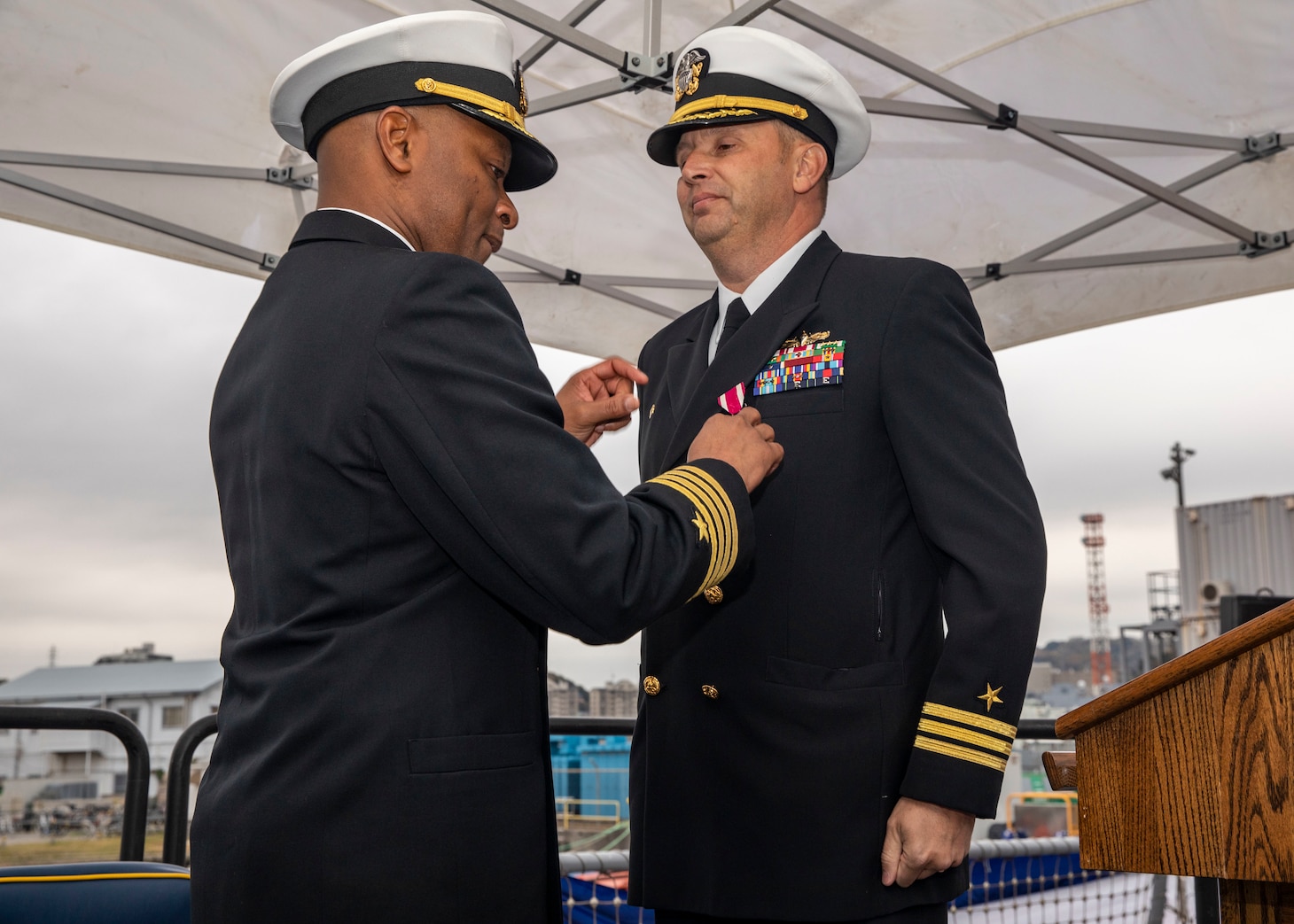 YOKOSUKA, Japan (Dec. 1, 2022) Capt. Walter Mainor, Commander, Task Force 71, presents a Meritorious Service Medal to Cmdr. Travis Montplaisir, outgoing commanding officer of Arleigh Burke-class guided-missile destroyer USS Howard (DDG 83), during a change of command ceremony aboard the ship, forward-deployed to Commander, Fleet Activities Yokosuka, Dec. 1. Howard is assigned to Commander, Task Force 71/ Destroyer Squadron (DESRON) 15, the Navy’s largest forward-deployed DESRON and the U.S. 7th fleet’s principal surface force. (U.S. Navy photo by Mass Communication Specialist 3rd Class Santiago Navarro)