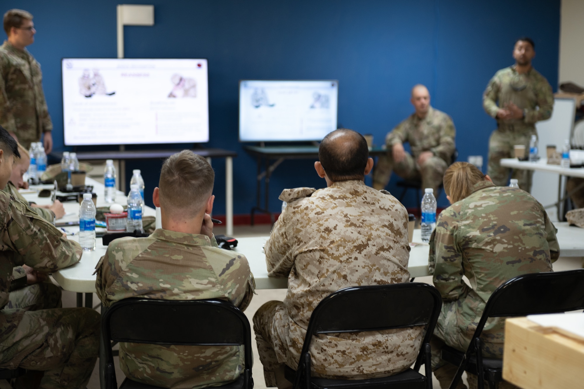 U.S. Army Soldiers assigned to Prince Sultan Air Base, and members of the Royal Saudi Land Forces listen in during a Tactical Combat Casualty Care training, Oct. 18, 2022.