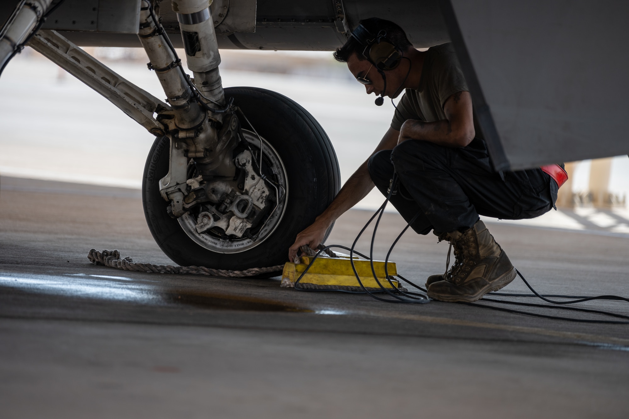 U.S. Air Force Senior Airman Stace Bechtel, a 77th Expeditionary Fighter Generation Squadron crew chief, removes chalks, prior to launching an F-16 Fighting Falcon, from Prince Sultan Air Base, Kingdom of Saudi Arabia Nov. 14, 2022.