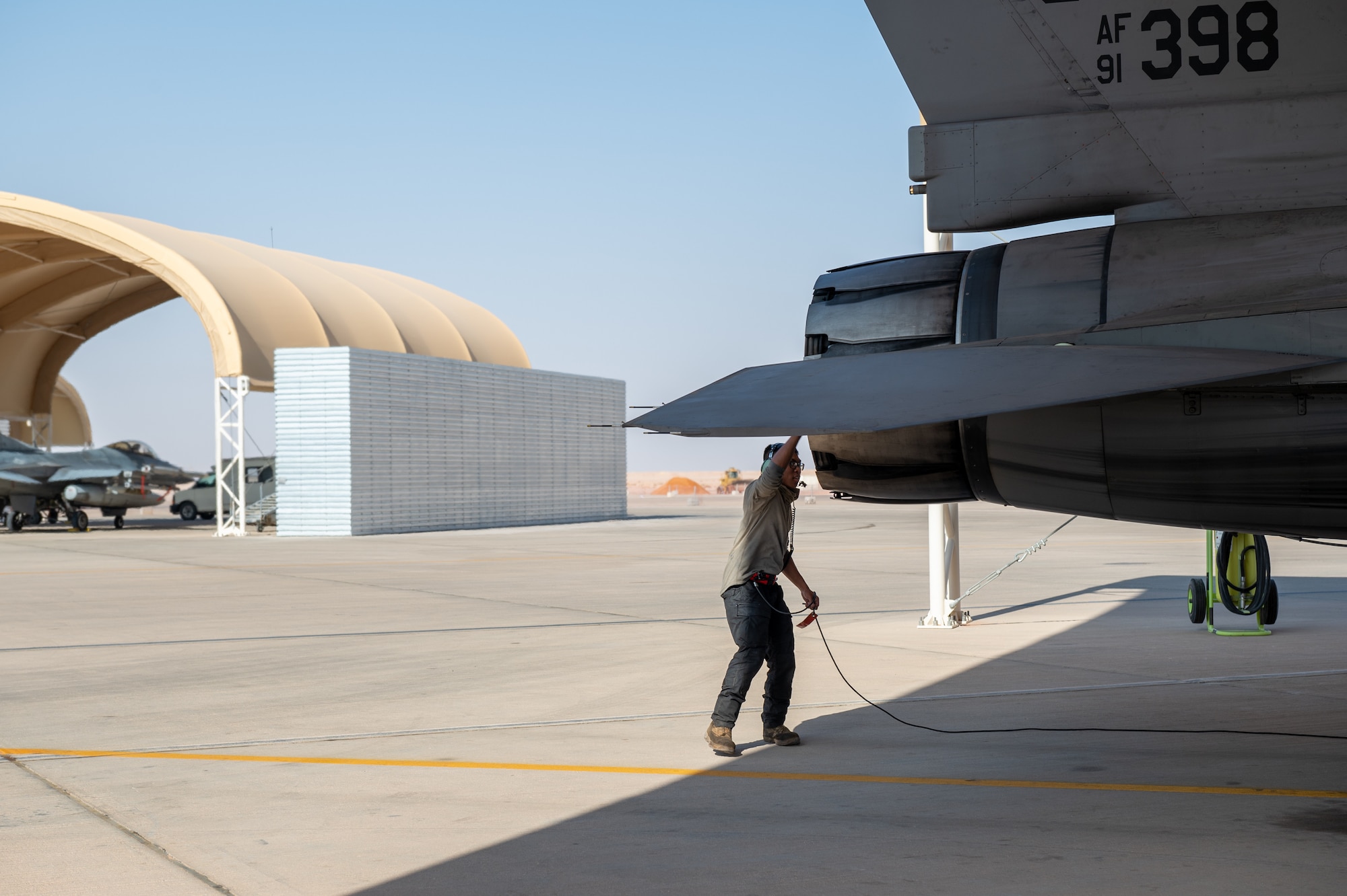 U.S. Air Force Airman 1st Class Jezreal Rae, a 77th Expeditionary Fighter Generation Squadron crew chief conducts a post flight inspection following an F-16 Fighting Falcon sortie launched from Prince Sultan Air Base, Kingdom of Saudi Arabia, Nov. 14, 2022.