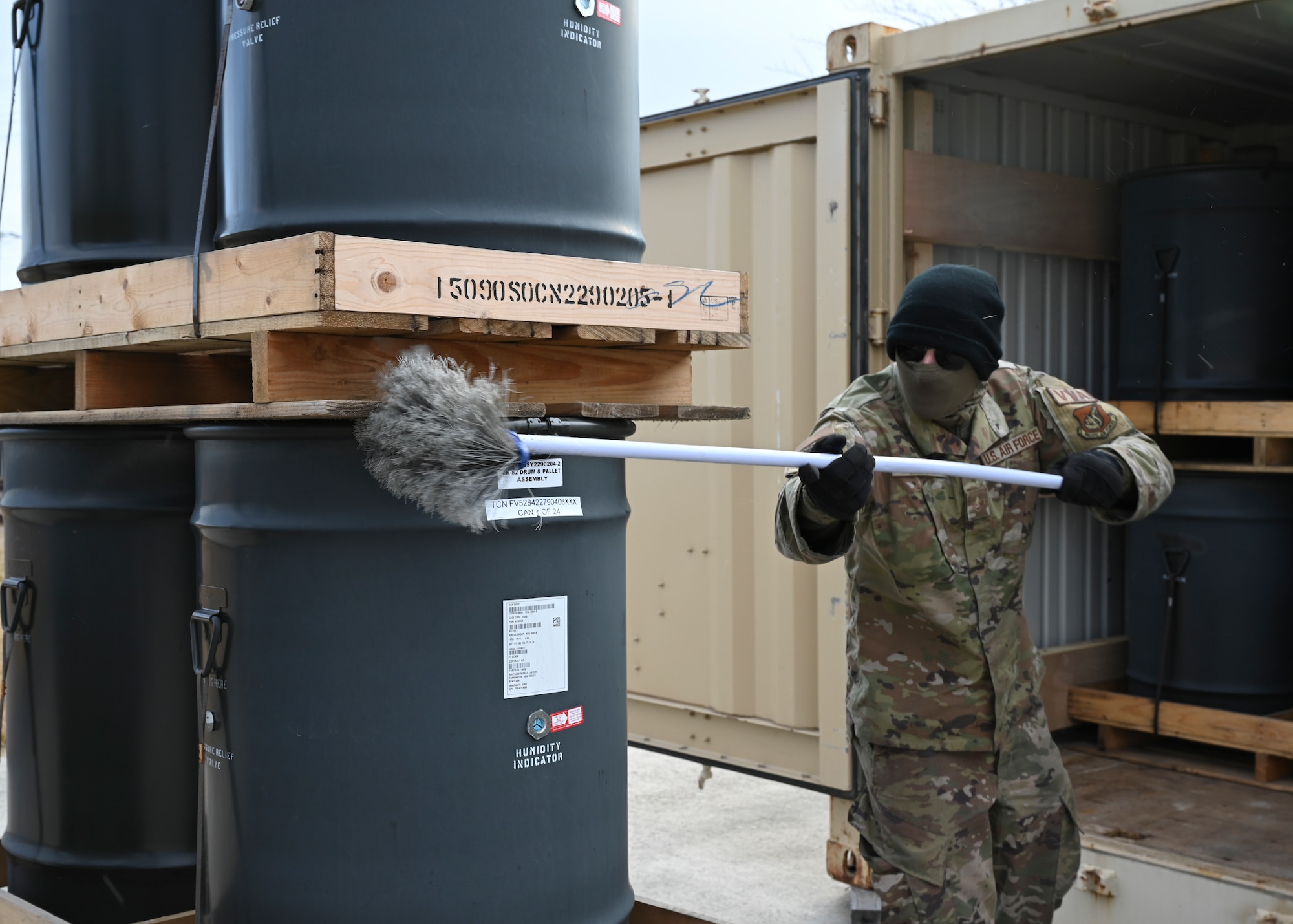 An Airman brushes a pallet.