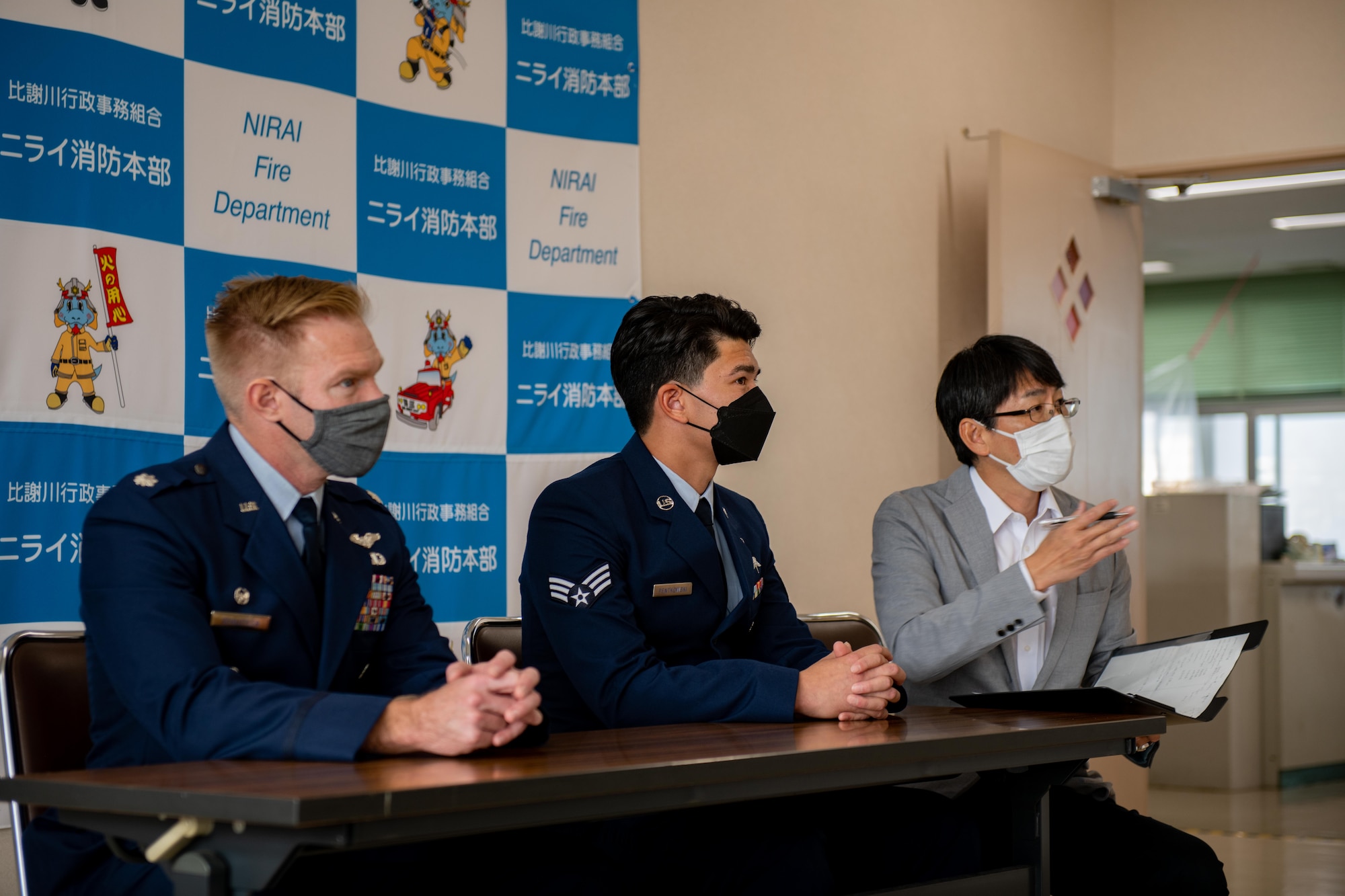 Members from Kadena Air Base speak to members from the local press