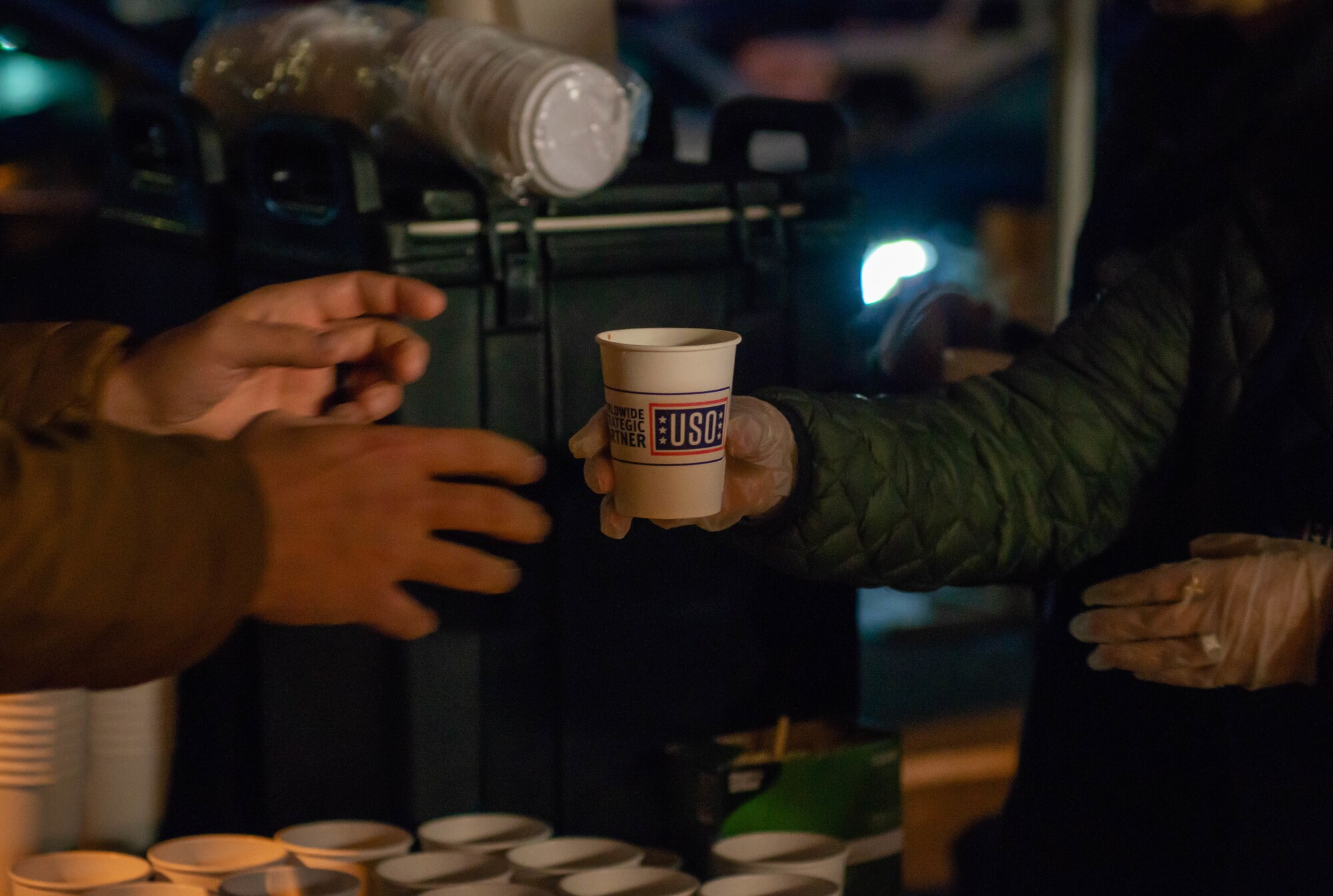 USO members give hot chocolate to families