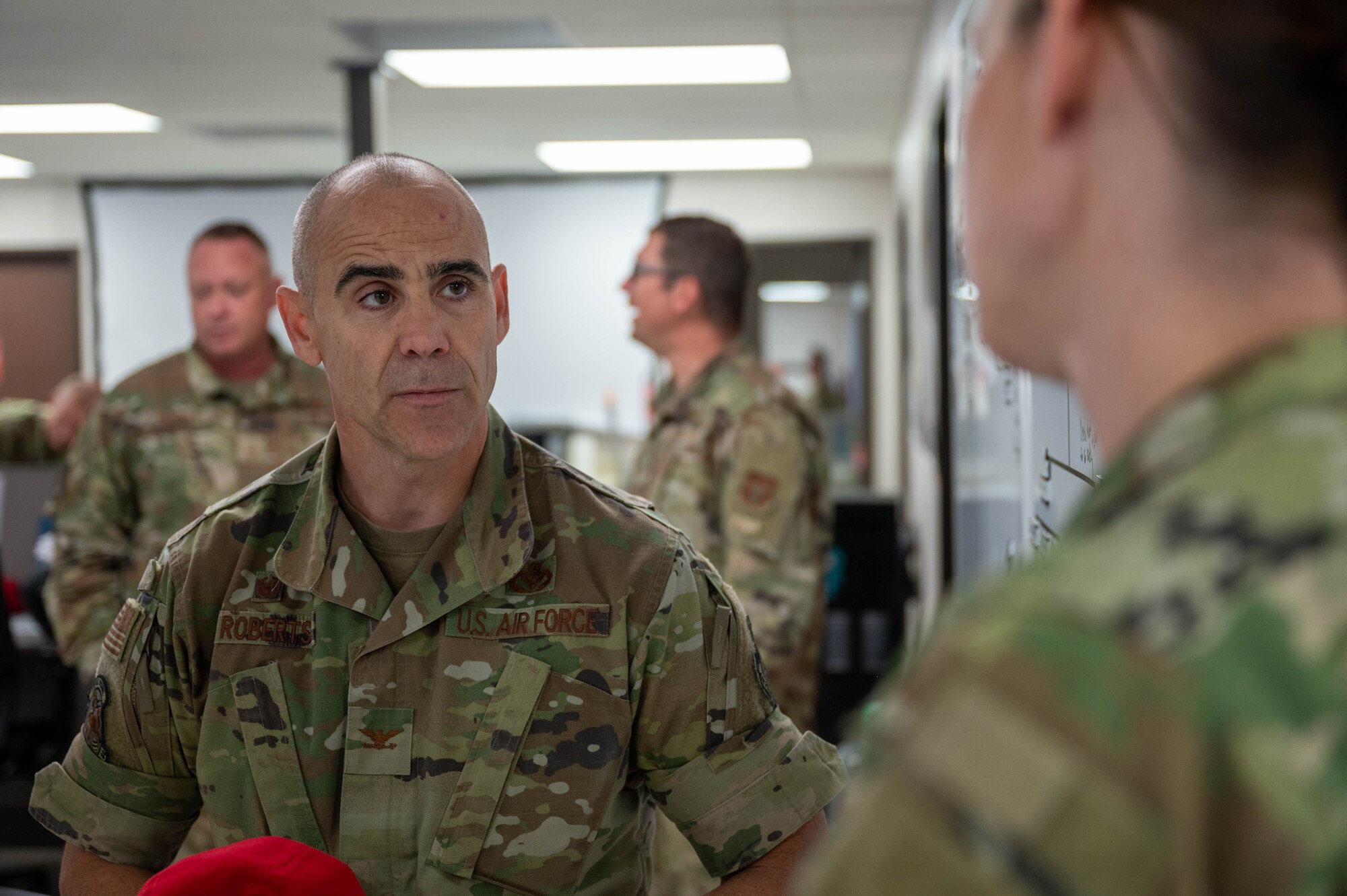 U.S. Air Force Col. Adam Roberts, the 555 RED HORSE Squadron commander, has a discussion with U.S. Air Force Capt. Caitlin Touchberry, the 555RHS operations deputy, at Nellis Air Force base, Nevada, September 20, 2022. Roberts stopped by several shops within the squadron in order to stay in close reach for those who may need it and to remain engaged with his fellow wingmen.