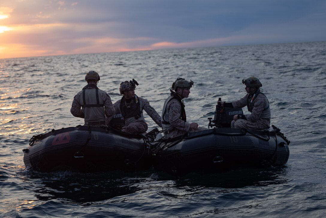 U.S. Marines with Charlie Company, 1st Reconnaissance Battalion, 1st Marine Division, sit in combat rubber raiding craft during helocast training as part of Steel Knight 23 off the coast of Marine Corps Base Camp Pendleton, California Dec. 2, 2022. Steel Knight is an annual combined arms live-fire exercise which ensures 1st MARDIV is optimized for naval expeditionary warfare in contested spaces, and is purpose-built to facilitate future operations afloat and ashore. (U.S. Marine Corps photo by Cpl.  Marshall)