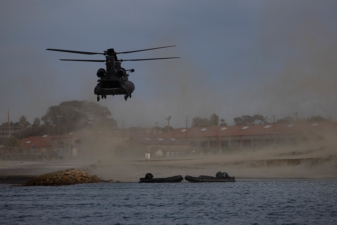 A U.S. Army MH-47 Chinook helicopter with 160th Special Operations Aviation Regiment lands near Del Mar Boat Basin during helocast training with U.S. Marines from Bravo Company, 1st Reconnaissance Battalion, 1st Marine Division, as part of Steel Knight 23 on Marine Corps Base Camp Pendleton, California, Dec. 2, 2022. Steel Knight is an annual combined arms live-fire exercise which ensures 1st MARDIV is optimized for naval expeditionary warfare in contested spaces, and is purpose-built to facilitate future operations afloat and ashore. (U.S. Marine Corps photo by Cpl. Marshall)