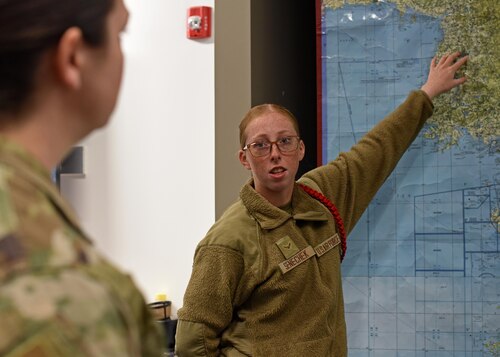 U.S. Air Force Airman 1st Class Leila Senechek, 315th Training Squadron student, briefs an instructor acting as a general officer during Operation Lone Star at Goodfellow Air Force Base, Texas, Nov. 28, 2022. Students spend five days collecting and utilizing data to create actionable intel to disseminate to instructors who act as leaders to make accurate and timely decisions. (U.S. Air Force photo by Airman 1st Class Sarah Williams)