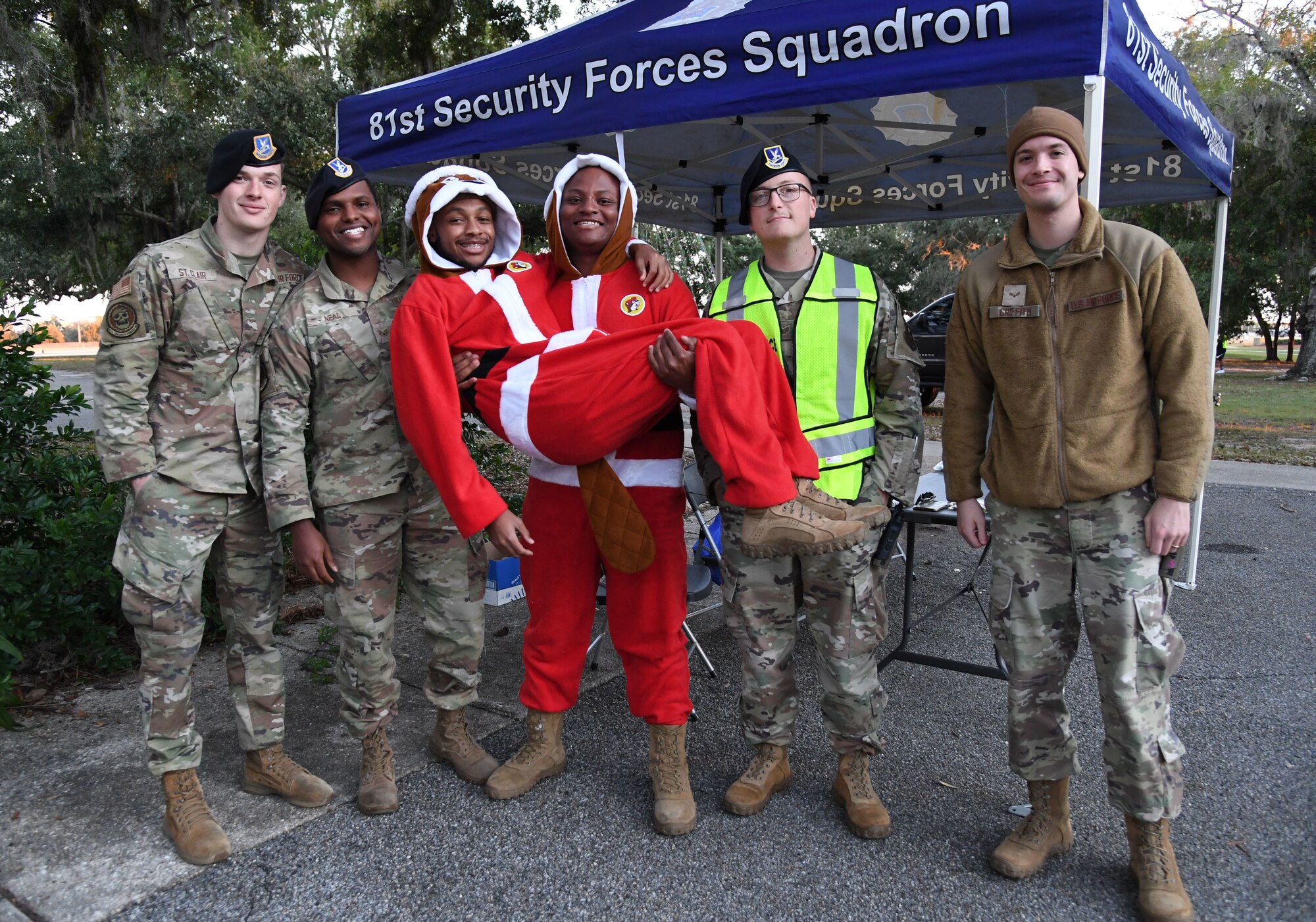 Members of the 81st Security Forces Squadron pose for a photo during Holiday in the Park at Keesler Air Force Base, Mississippi, Dec. 1, 2022.