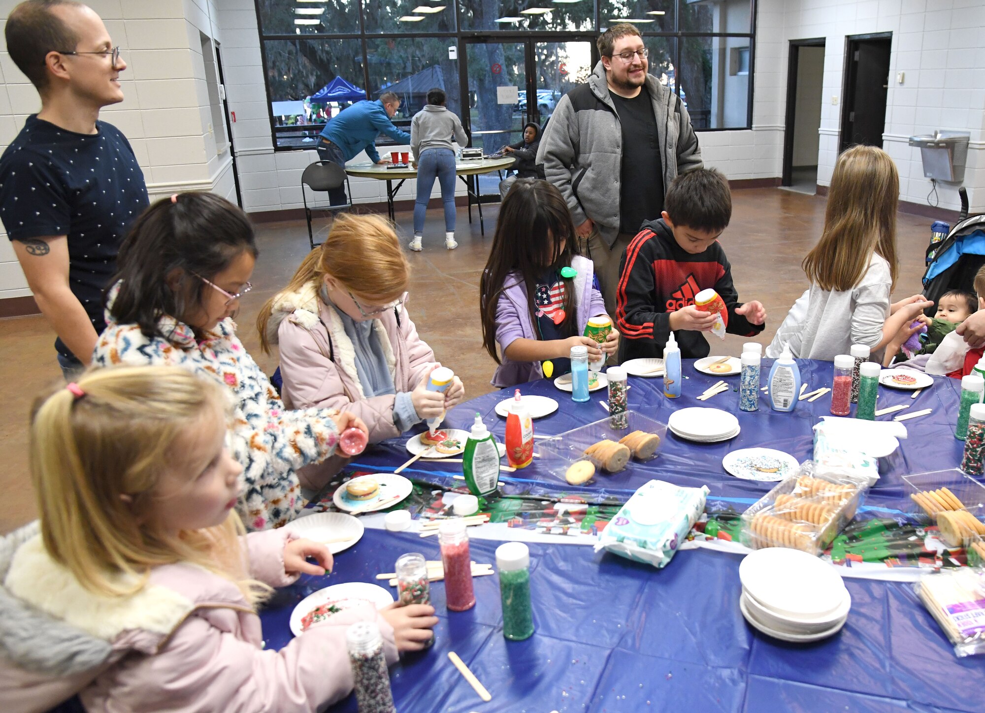 Military children decorate cookies during Holiday in the Park at Keesler Air Force Base, Mississippi, Dec. 1, 2022.