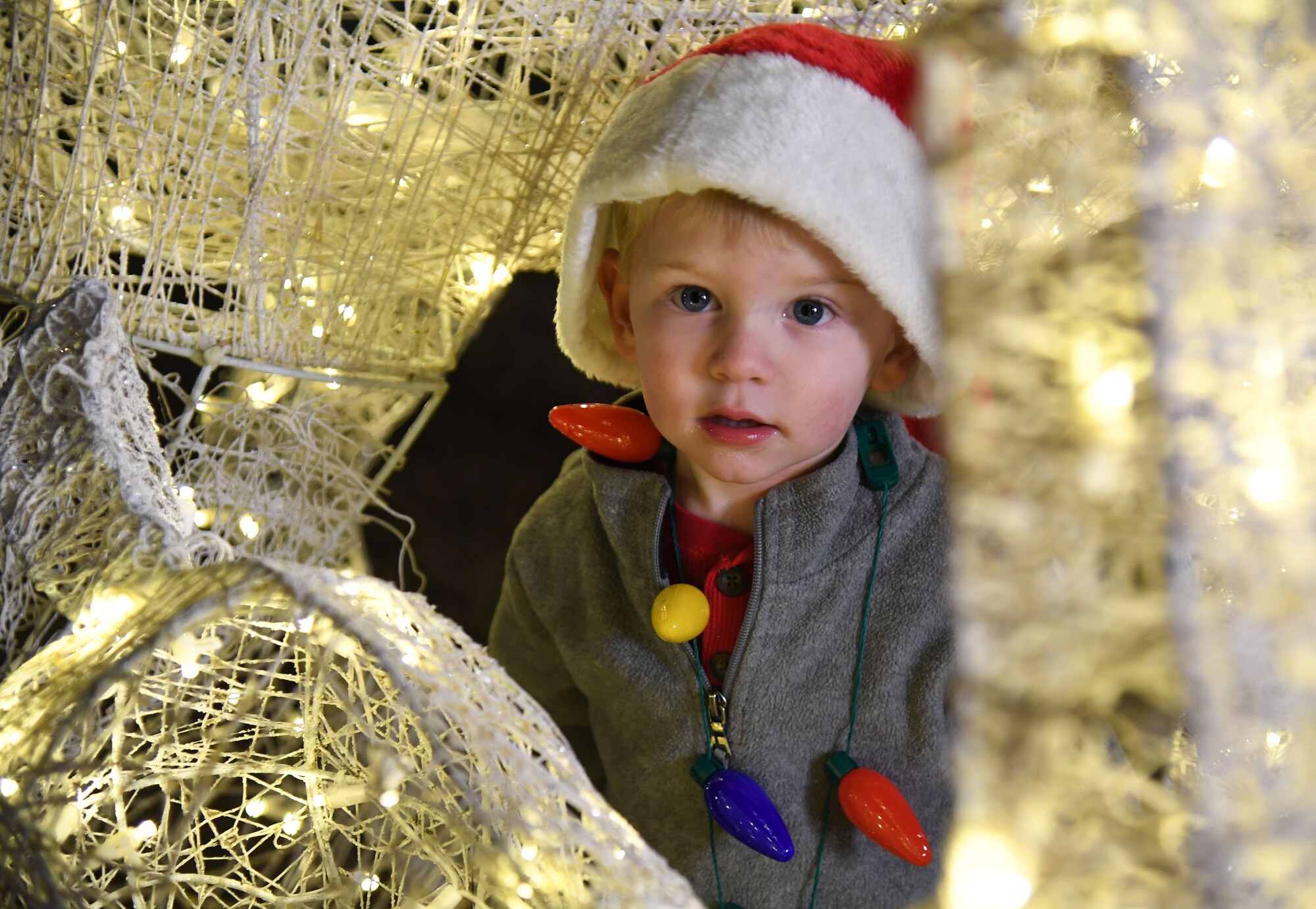 Aiden Jensen, son of U.S. Air Force Senior Airman Shawn Jensen, 81st Diagnostic and Therapeutics Squadron radiologist technician, inspects Christmas lights during Holiday in the Park at Keesler Air Force Base, Mississippi, Dec. 1, 2022.